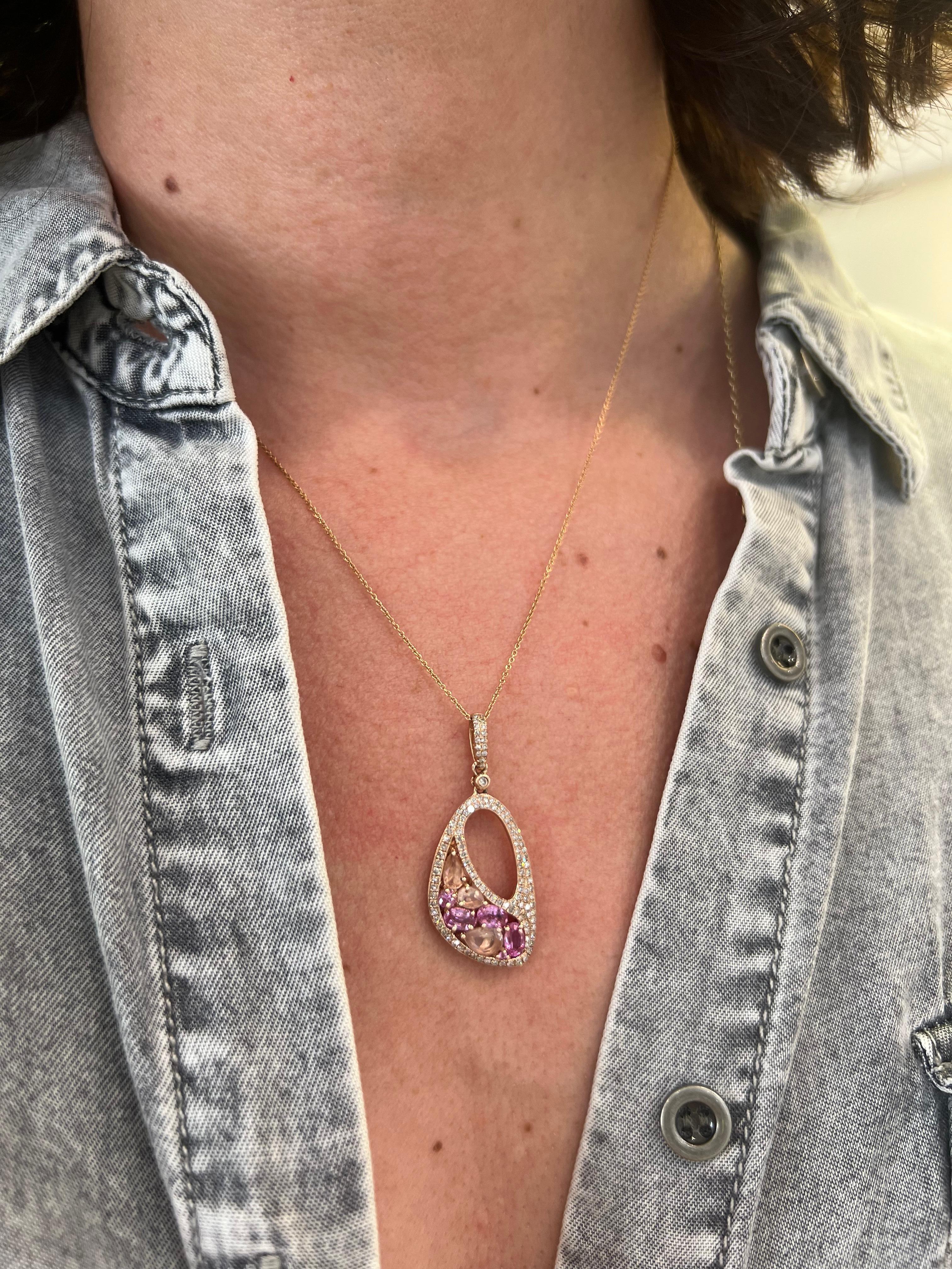 14K rose gold pendant necklace with diamonds, rose quartz and pink sapphires.

Features

14k rose gold 
.42 carat total weight round diamonds
4 oval shape faceted pink sapphires
3 faceted pear shape rose quartz
14K, 18' rose gold chain with