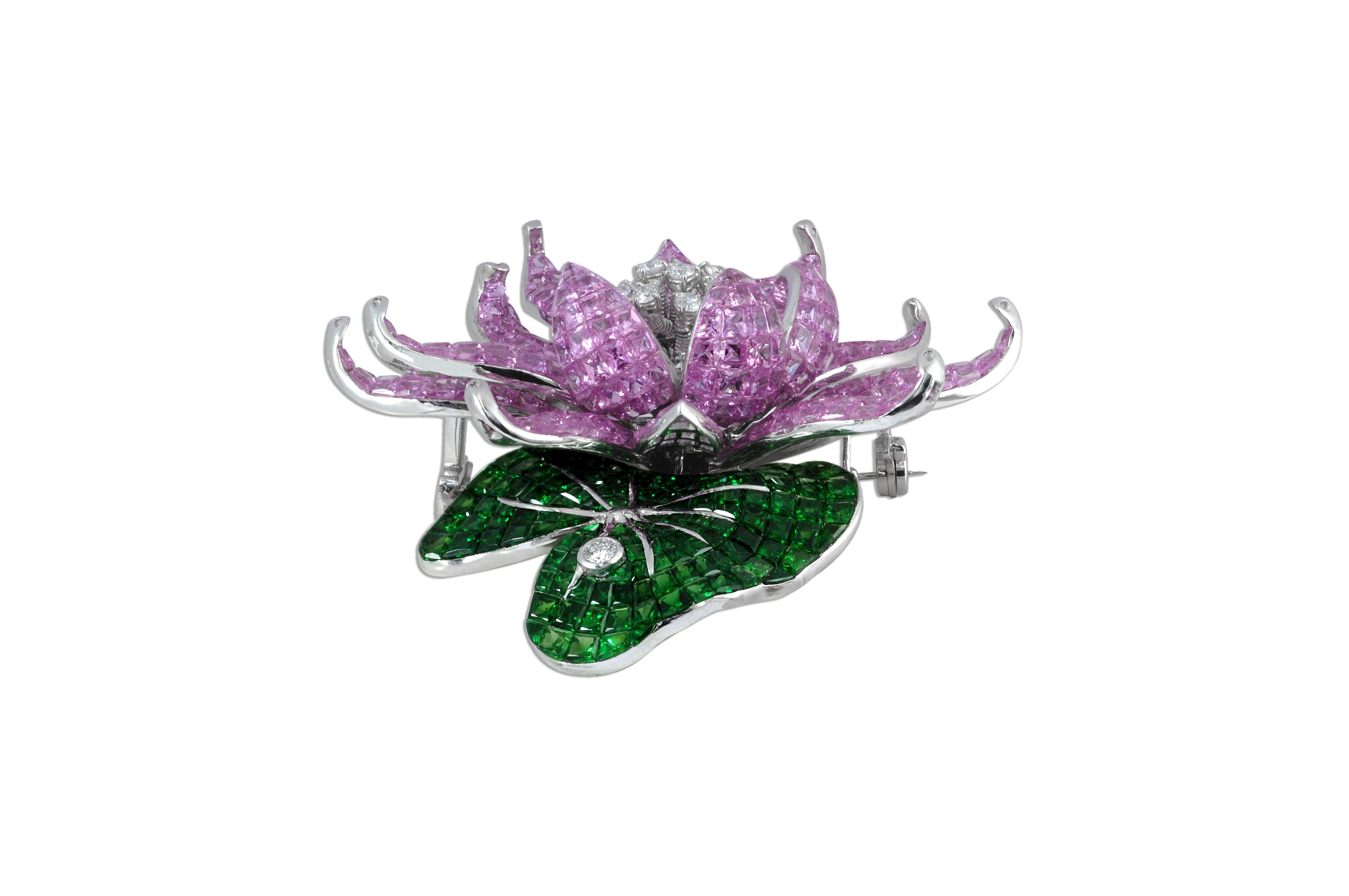 Pink Sapphire 109.34 carats, Tsavorite 28.43 carats with Diamond 1.46 carats Brooch set in 18 Karat White Gold Settings

Width: 7.0 cm
Length: 7.5 cm 

