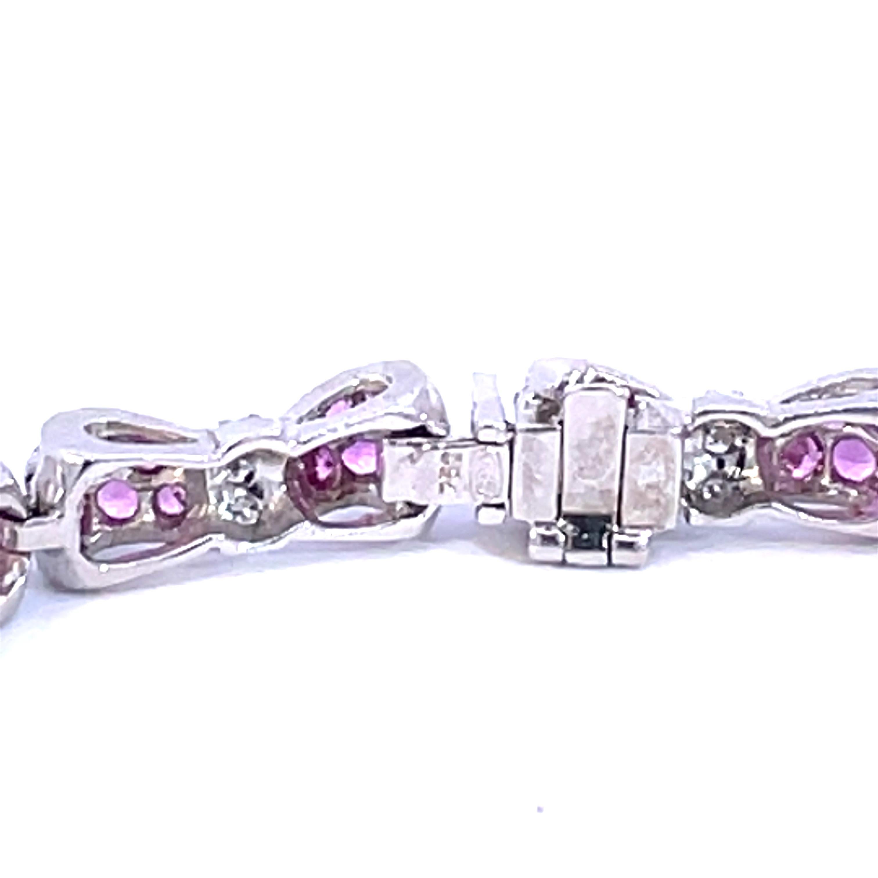 An Beautiful Bow Tie Bracelet set with natural pink  sapphires and natural white diamonds in 18kt white gold.

144 natural pink sapphires weighing 6.00ct total weight

36 natural white diamonds weighing 0.30ct total weight

18kt white gold, 18