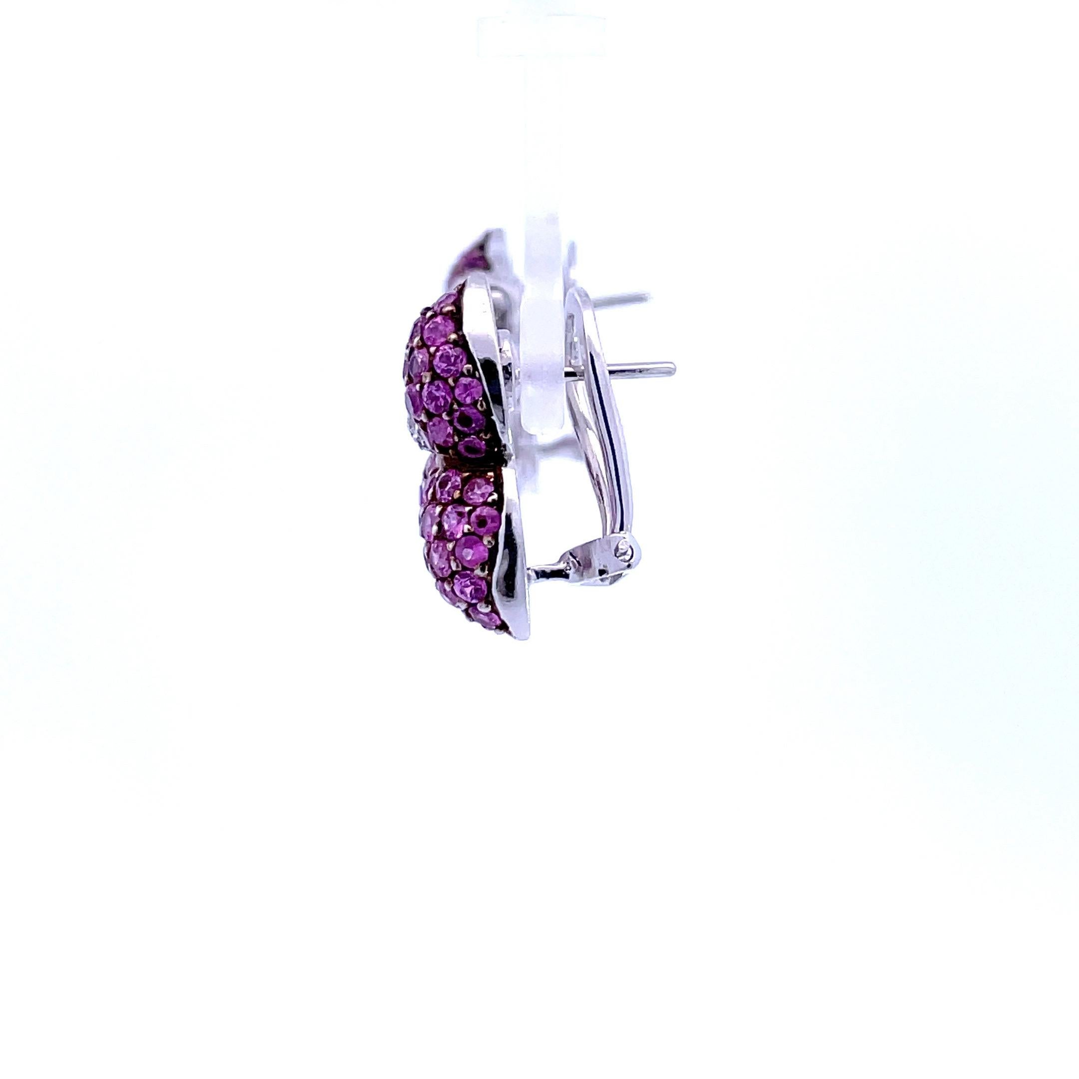 A large pair of natural pink sapphire and natural diamond earrings set in 18 Kt  white gold highlighted with a black rhodium finish straight post and omega system.

40 Brilliant cut natural diamonds weighing 0.30ct total weight, quality G/VS

128