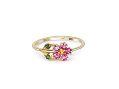 Pink sapphires flower ring in 14 karat gold.