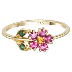 Pink sapphires flower ring in 14 karat gold. 
