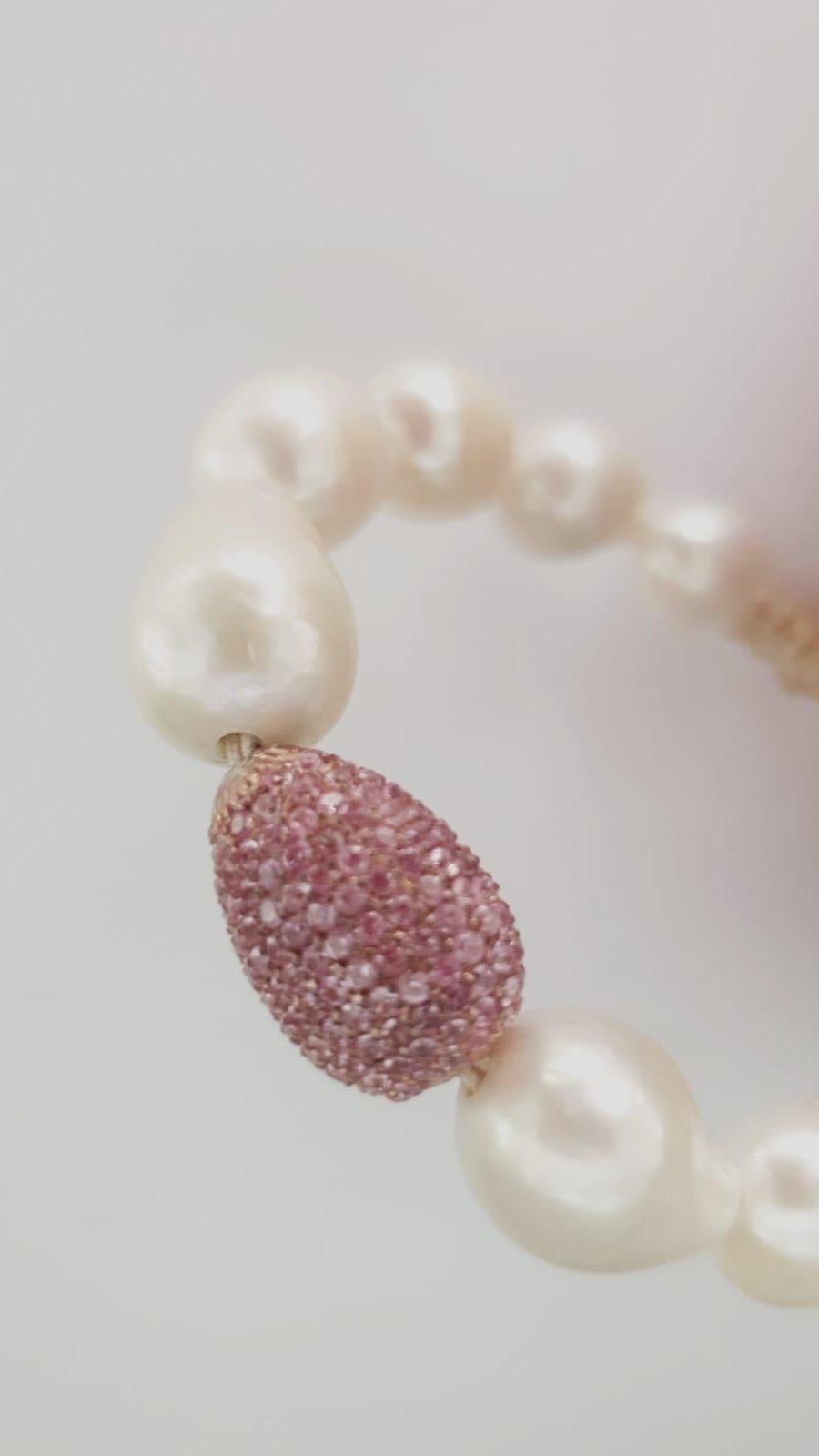 Nice bracelet made up of  pink sapphires pave on silver setting, baroque white pearls and macrame clasp. 
Pink sapphires pave ct. 3,75
Baroque white pearls
macrame clasp system
Total diameter cm 7 - it fits well for a medium wrist ( about 15-16 cm) 