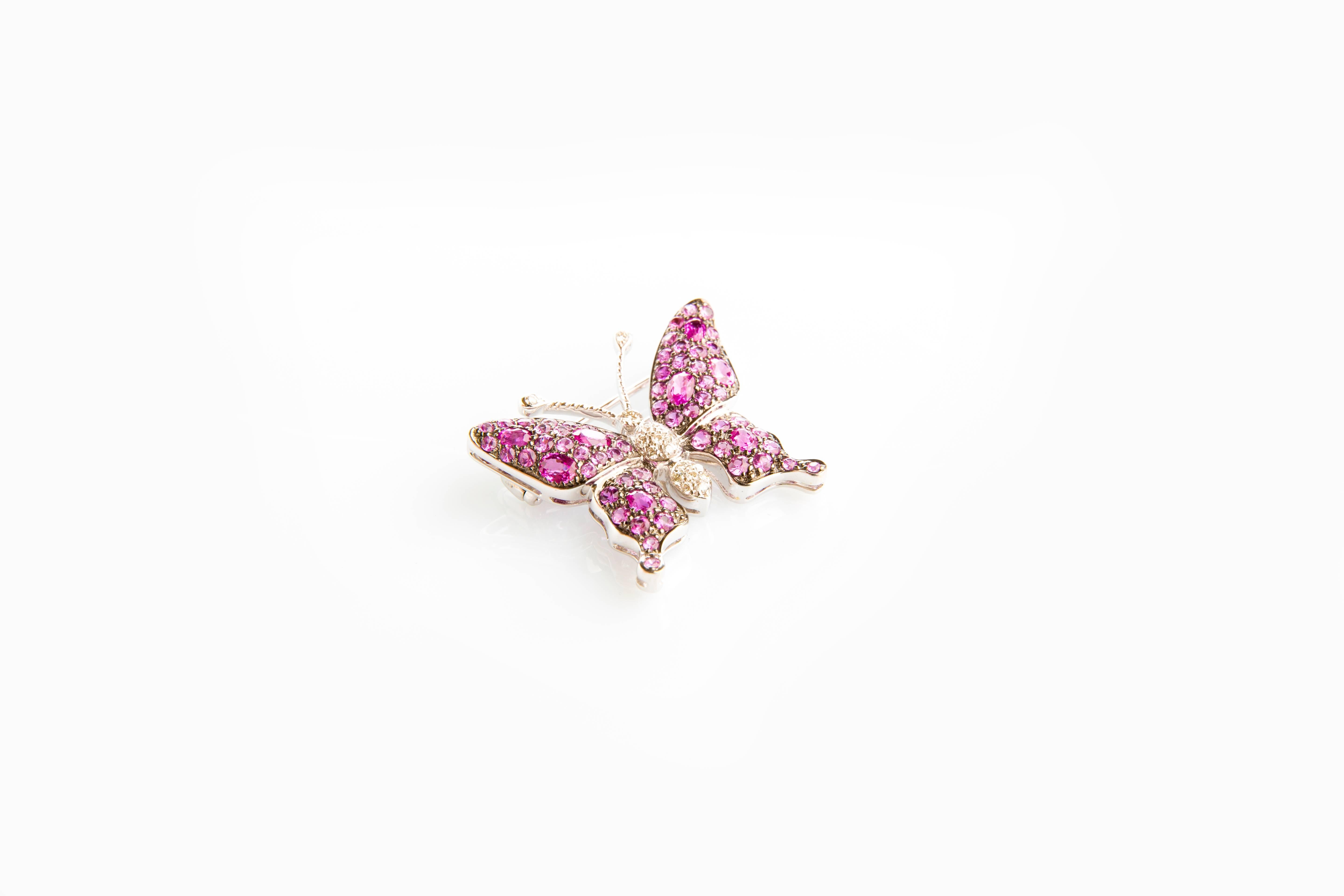 Set in 18K white gold, this glittering handcrafted brooch black rhodinated, features Pink Sapphires 1.53 carat, Diamonds 0.16ct H-I/vs 5.20 carats, Pink Tourmalines 0.46 carats and Rubellites 0.52carats.
Add a flutter of charm to any outfit with