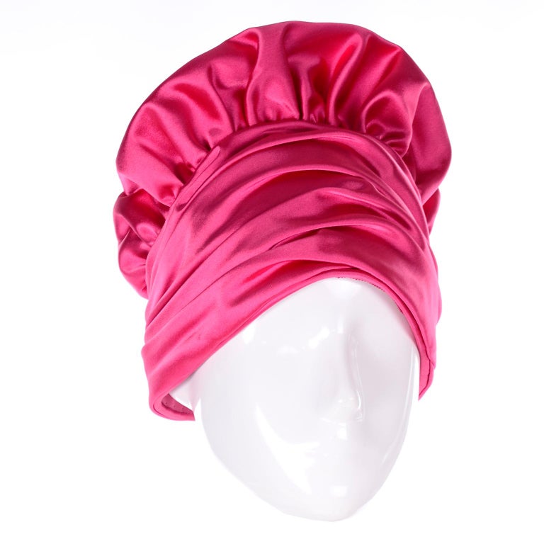 This is an incredible pink satin vintage hat that is gathered around the structured hat form, with a pleated flounce off the top! Nicholas Ungar was an exclusive high end boutique in Portland, Oregon that mainly sold furs but also sold designer