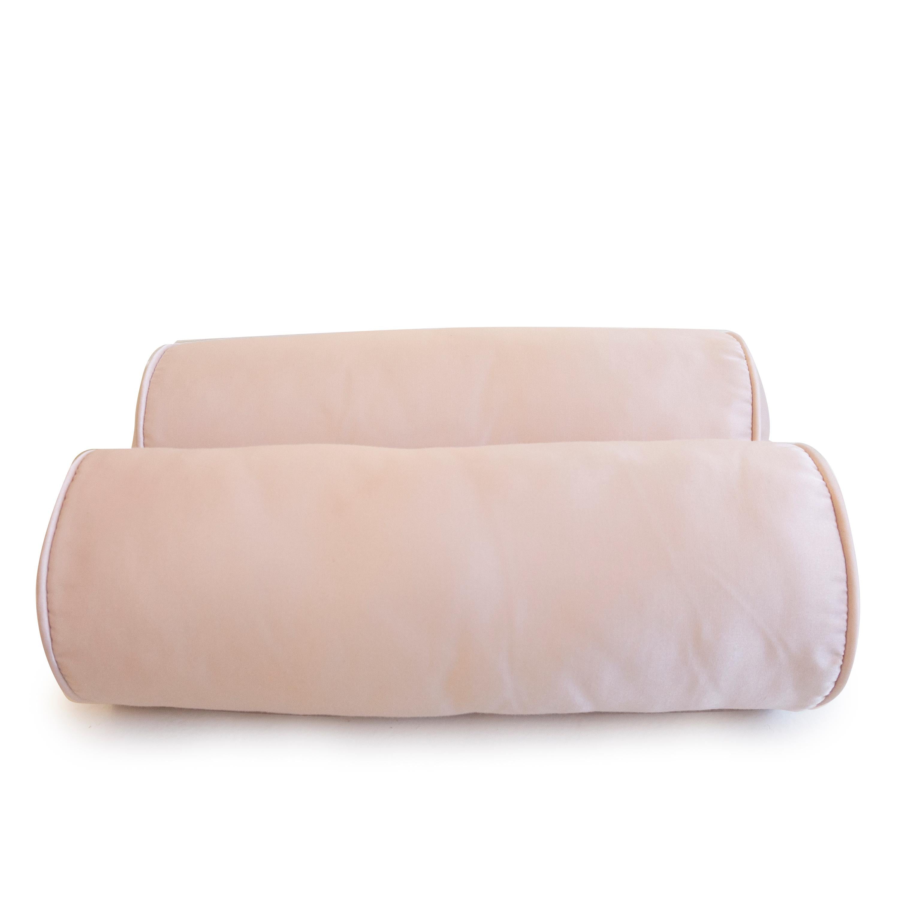 A pair of pink satin bolster pillows. Great for a bed, chair or sofa. Hand sewn in our studio in Norwalk, Connecticut. 

Measurements: 16
