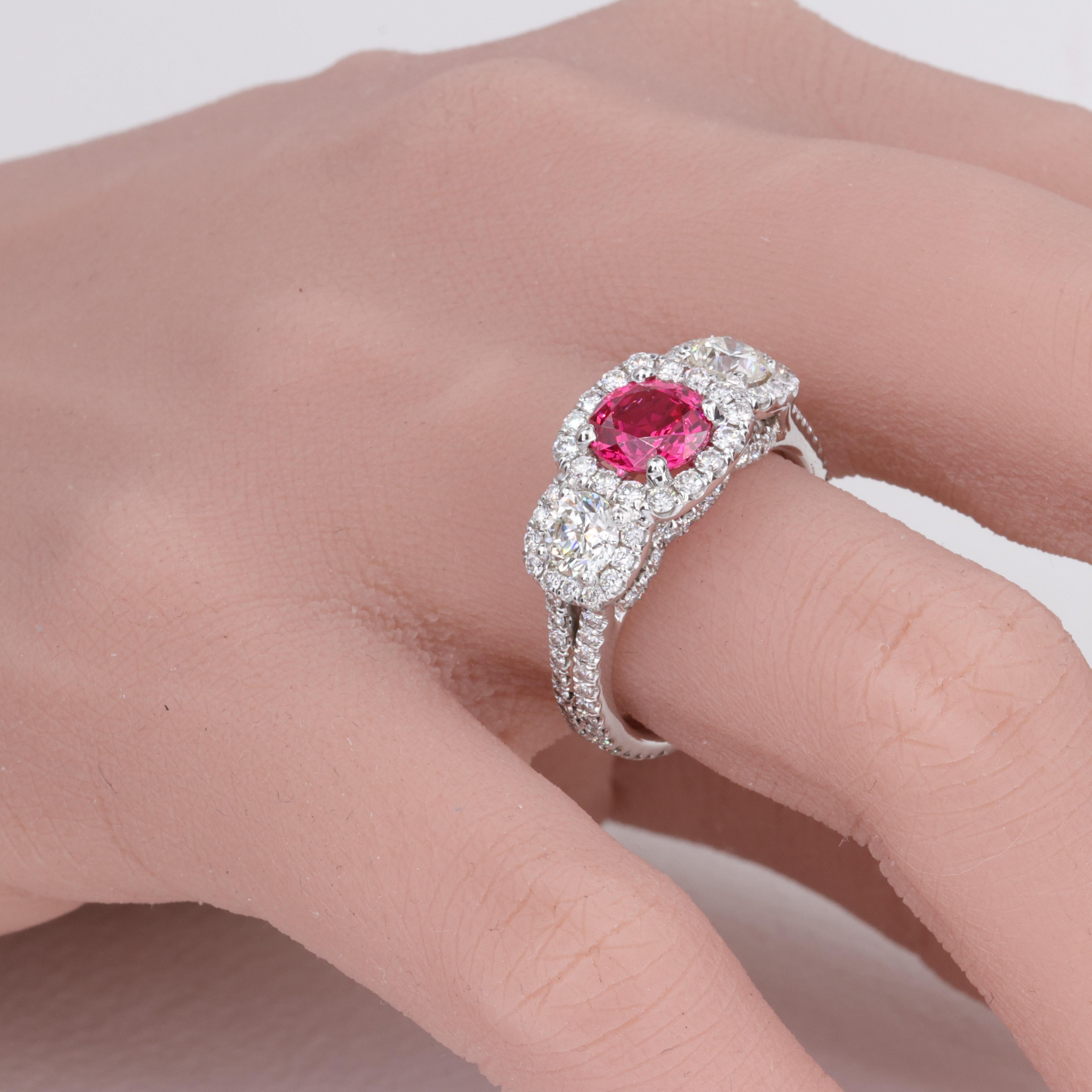 1.44 Carat Pink Spinel G.I.A. and Diamond Three Stone Halo Ring 

Approximately 2.00 carats of round brilliant cut diamonds. 

Finger size 7.25 US