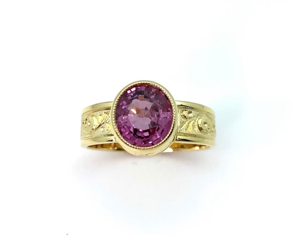 This beautiful ring features a pretty rose-colored pink spinel, bezel set in an 18k yellow gold setting custom made for this lively gem! The pink spinel is a medium, purplish pink color and sure to make you feel happy every time you wear this ring.