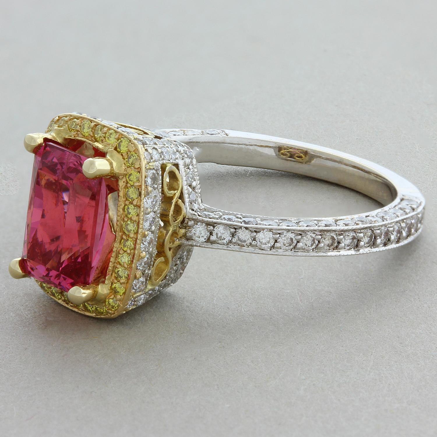 An alluring pink spinel weighing 1.70 carats haloed by the warm hue of 0.78 carats of yellow diamonds with white diamonds along the shank of the ring. The radiant cut spinel and the round cut yellow diamonds are set in 18K yellow gold to accentuate