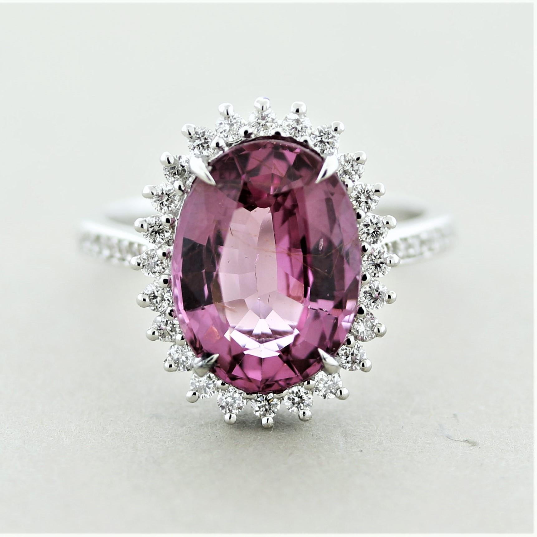 A beautiful ring with a special spinel weighing 5.57 carats which has a bright and vibrant pink color. It is free from eye-visible inclusions allowing the stones natural brilliance to shine. It is accented by 0.43 carats of round brilliant-cut