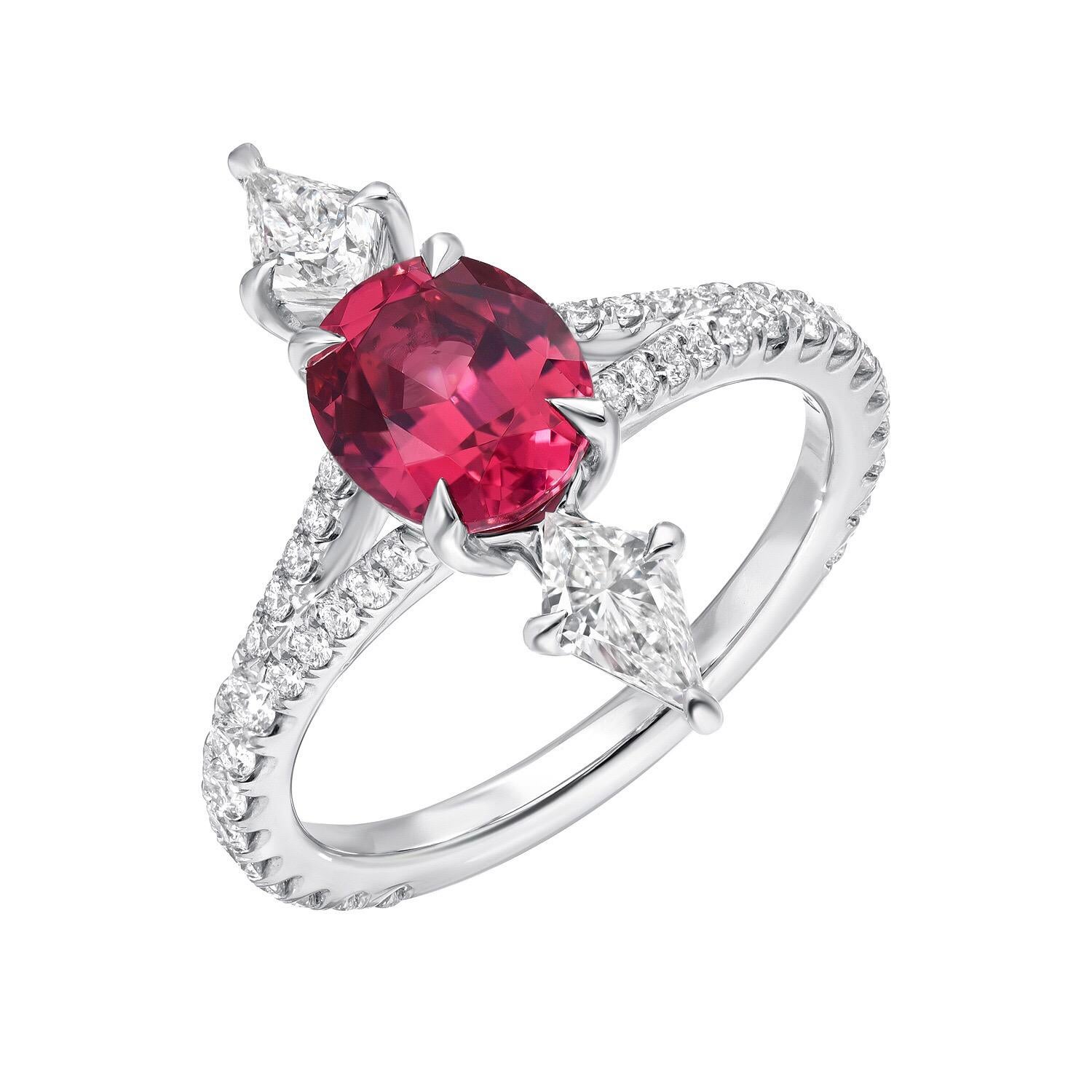 Ultra fine Pink Spinel oval, weighing a total of 1.47 carats, is joined by a pair of kite shaped diamonds, E/VS1, weighing a total of 0.48 carats, and adorned by a total of 0.50 carats of round brilliant diamonds on the shank, to create this