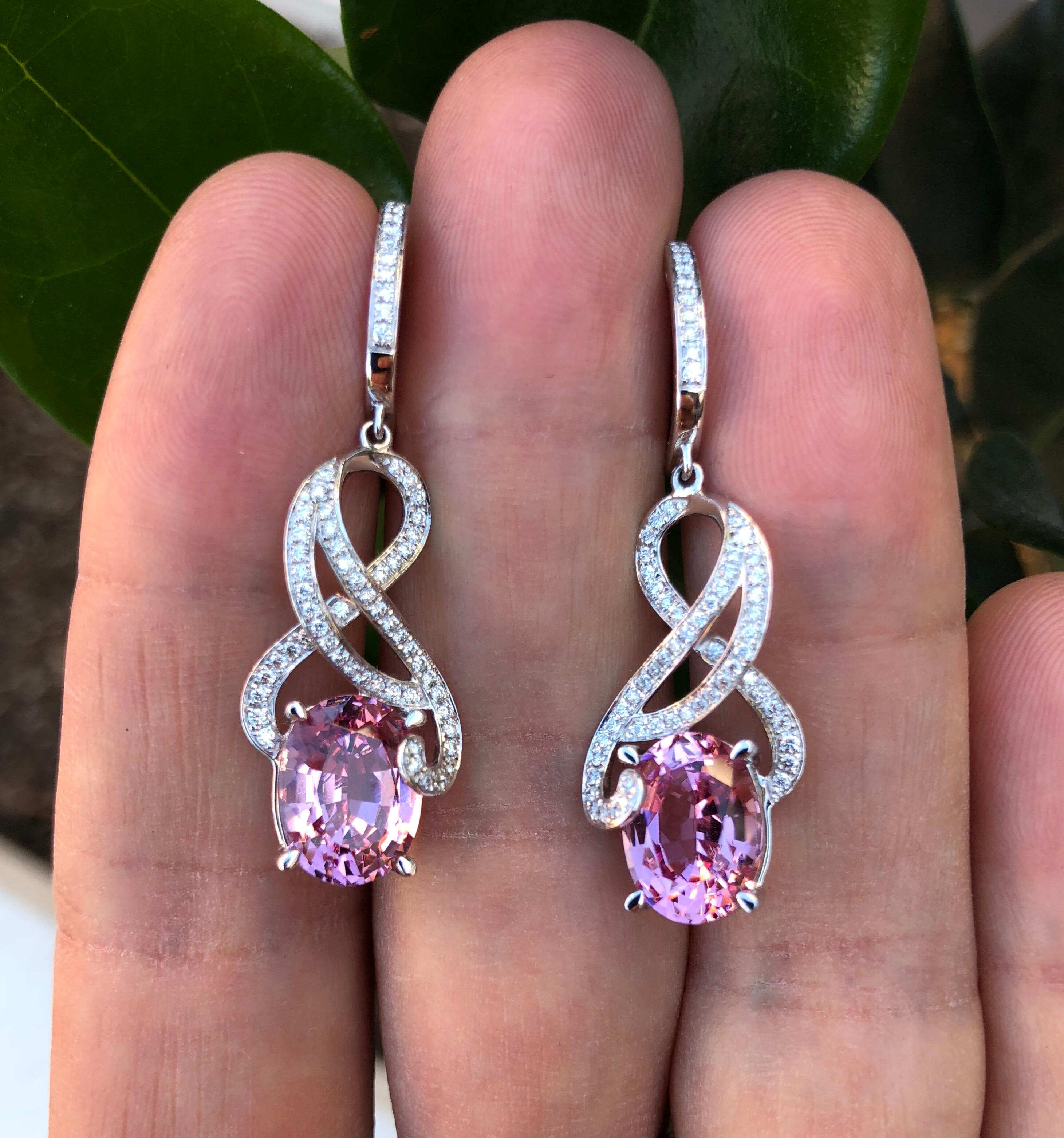Pink Spinel earrings centering a pair of extra fine 7.00 carat ovals, accented by round brilliant diamonds weighing a total of 0.52 carats.
18K white gold earrings for women crafted by hand in the USA.
Length: 1.5 inches.
Returns are accepted and
