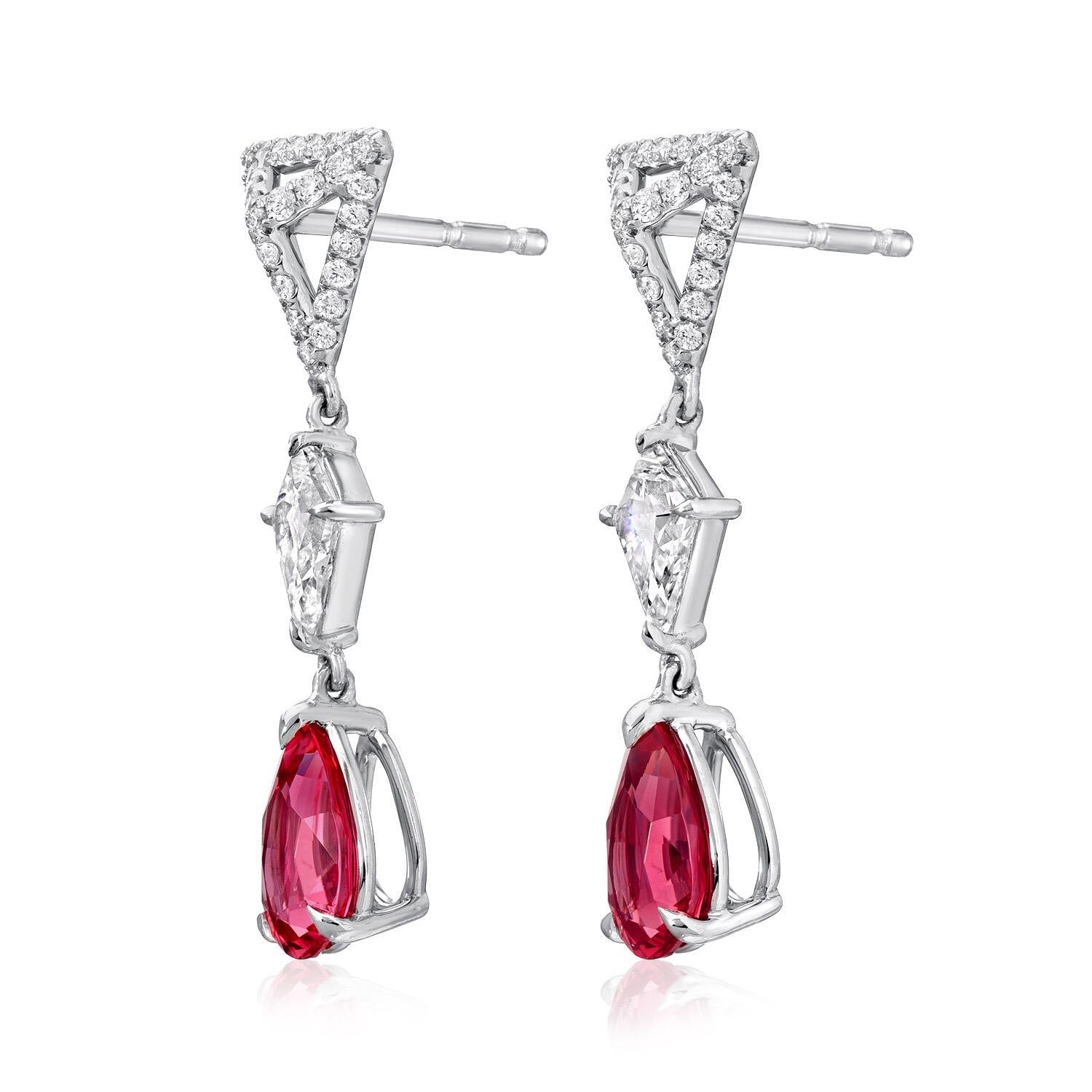 Hot Pink Spinel pear shapes, weighing a total of 1.83 carats, suspending from our signature three dimensional, eight millimeter triangle studs, set with a total of 0.30 round brilliant diamonds, and a pair of kite shaped diamonds weighing a total of