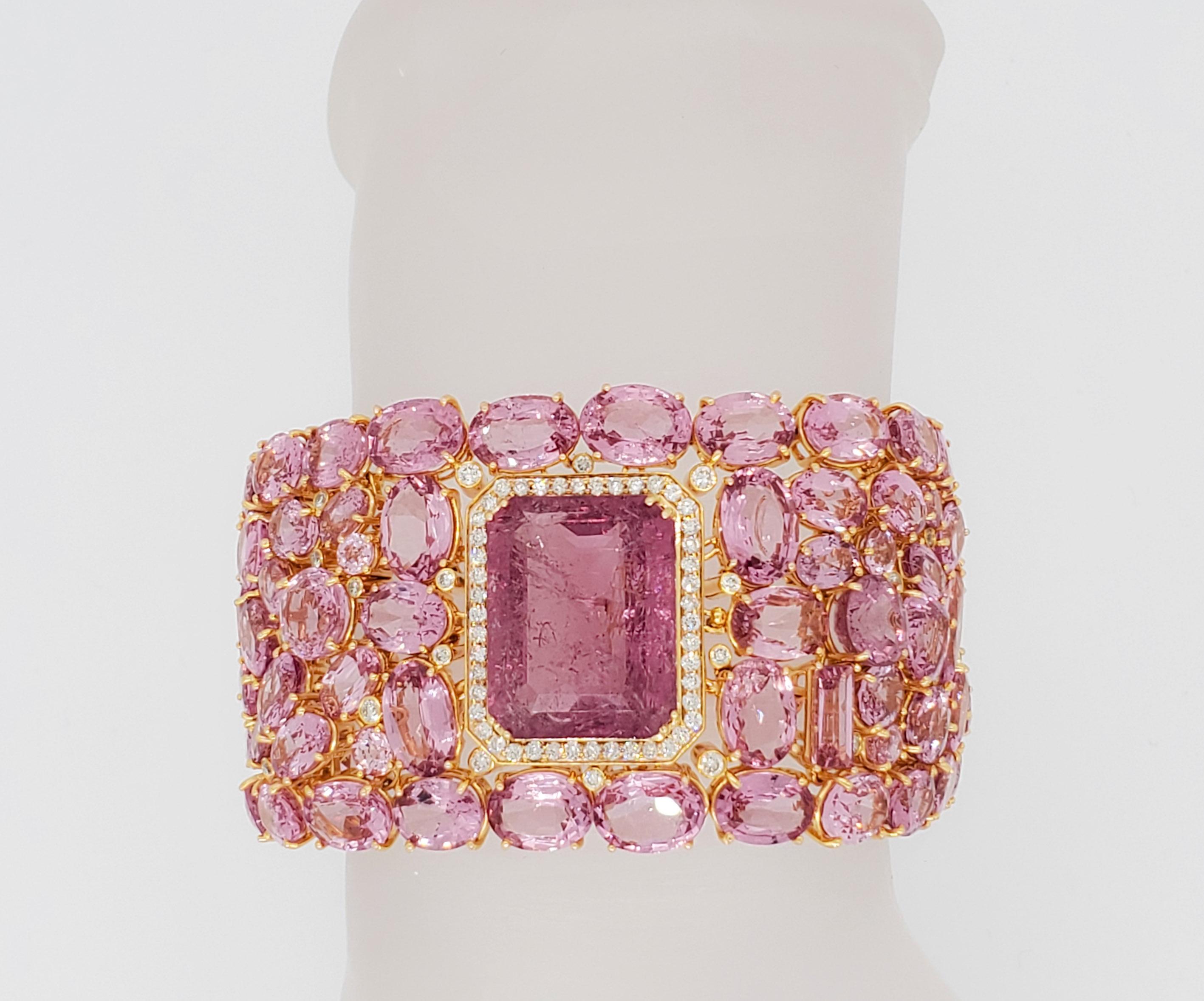 Absolutely gorgeous 25.16 ct. pink spinel emerald cut with 127.62 ct. pink spinel ovals, rounds, and emerald cuts.  White diamond scattered throughout.  Handmade in 18k yellow gold.  Total of 116 stones.