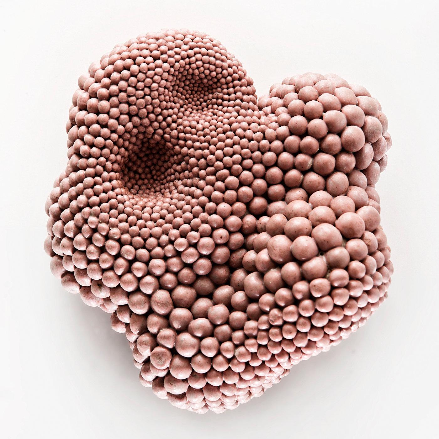 Unique and evocative, this sculpture is characterized by a natural, coral-inspired shape with an irregular and textured surface. The grès is modeled and shaped, the individual beads of varying sizes arranged to give the illusion of depth. Entirely
