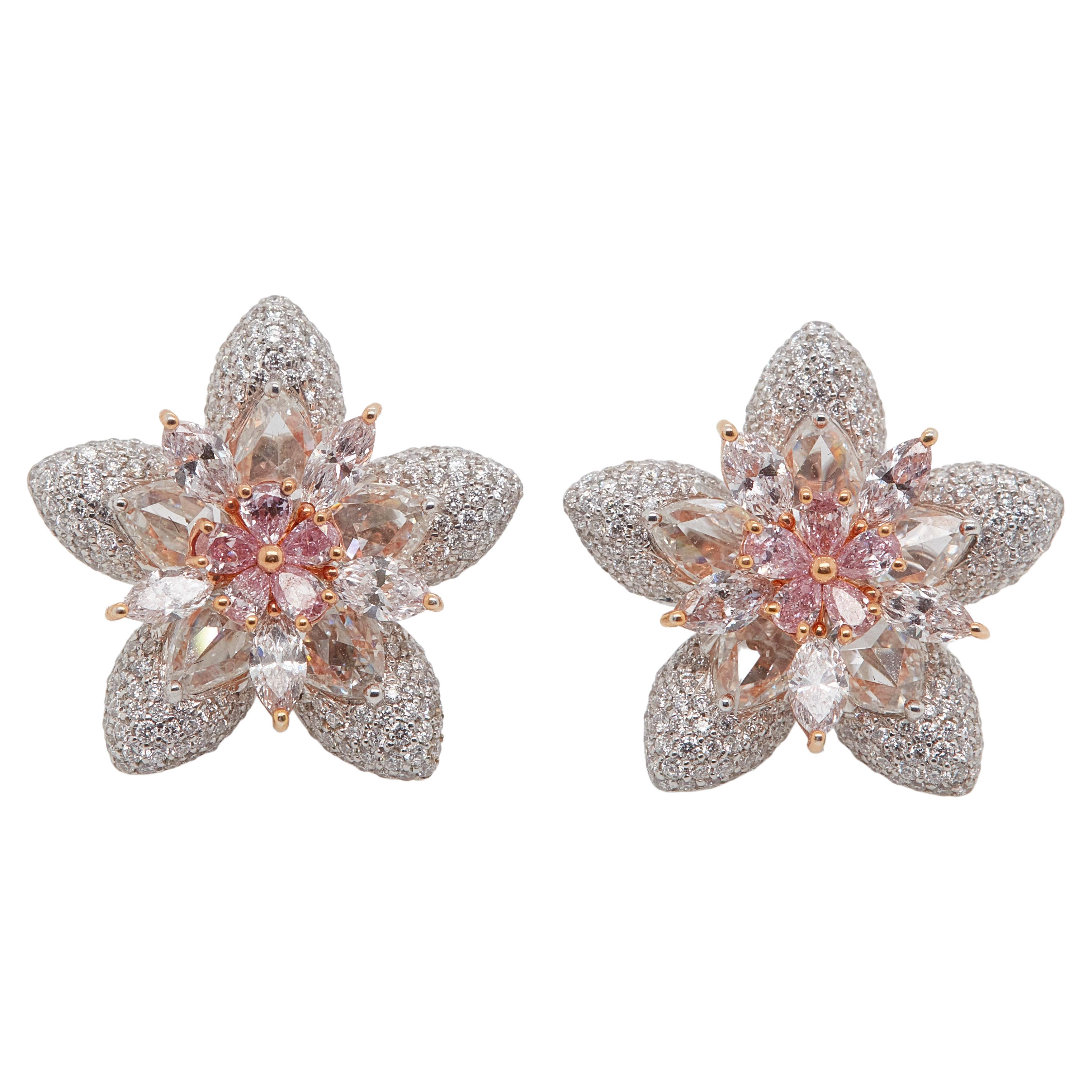 A perfectly matched earrings featured Pink Star Marquise-cut Fancy Pink Diamond Stud Earrings EGL Certified diamonds set in a flower motif. These earrings are crafted in 18k white and pink gold feature 10 pear shape fancy pink diamonds weighing 0.47