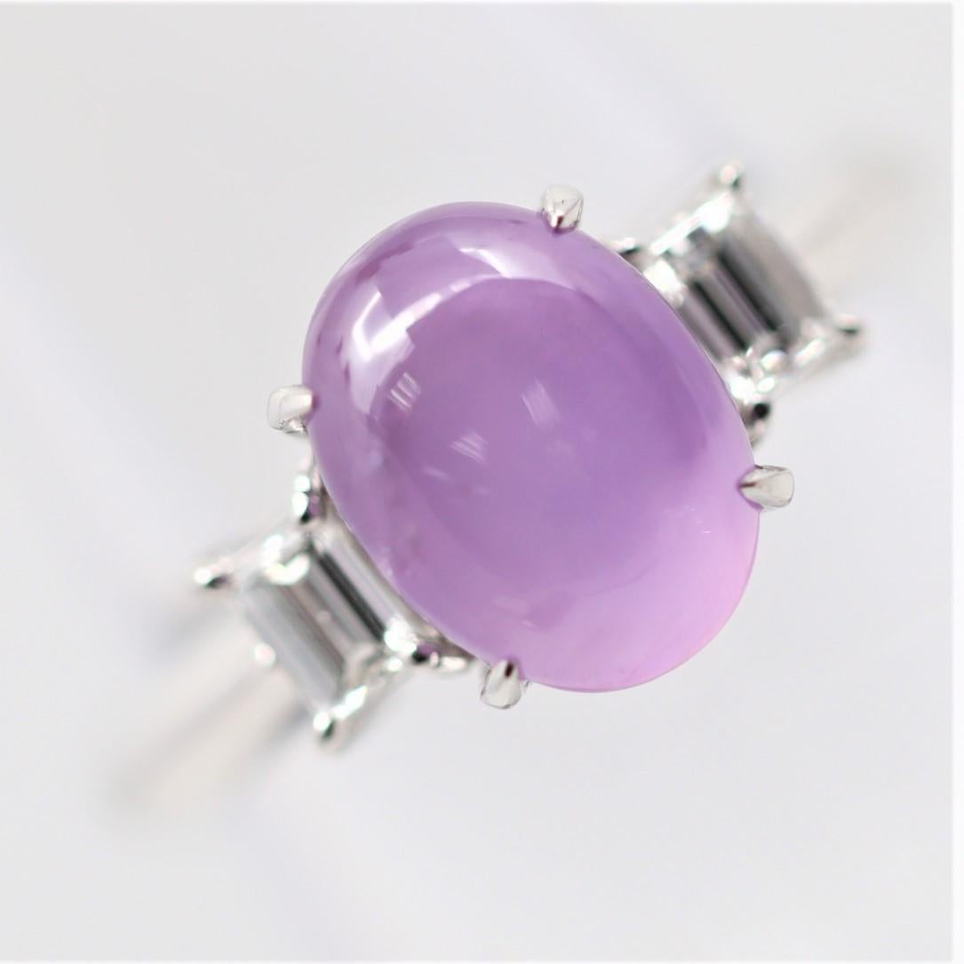 A bright and lively star sapphire with a vibrant pink color! It weighs 4.83 carats and has a strong 6-rayed star when a light hits its top. Some may consider this a star ruby due to its color as it is almost red. It is complemented by 2 step-cut