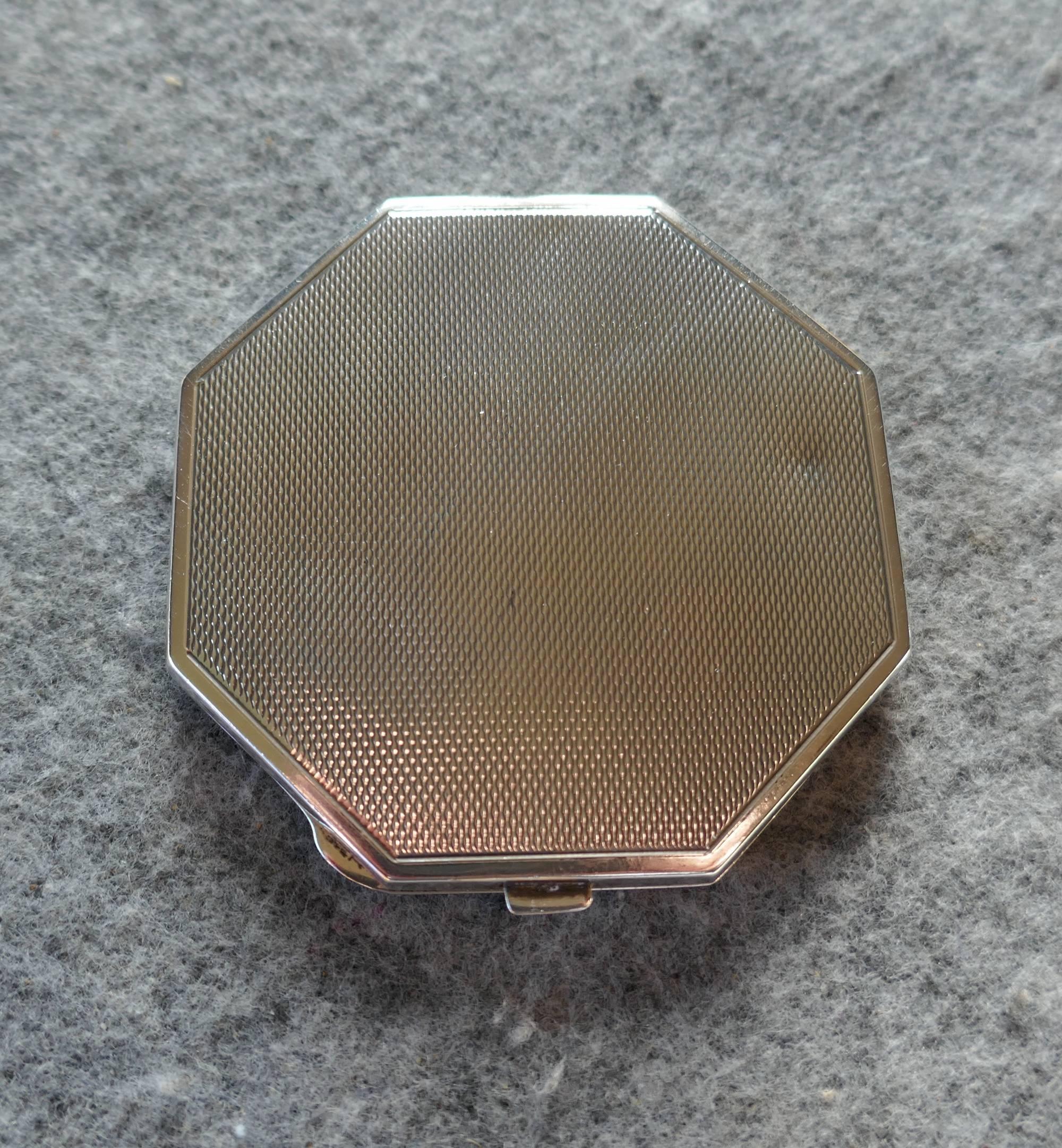 Pink sterling silver guilloche enamel Art Deco compact case 

This beautiful compact has an octagonal shape, the rose pink enamel radiates like sun burst from the bottom with an additional enamel border around the edge
The compact is in excellent