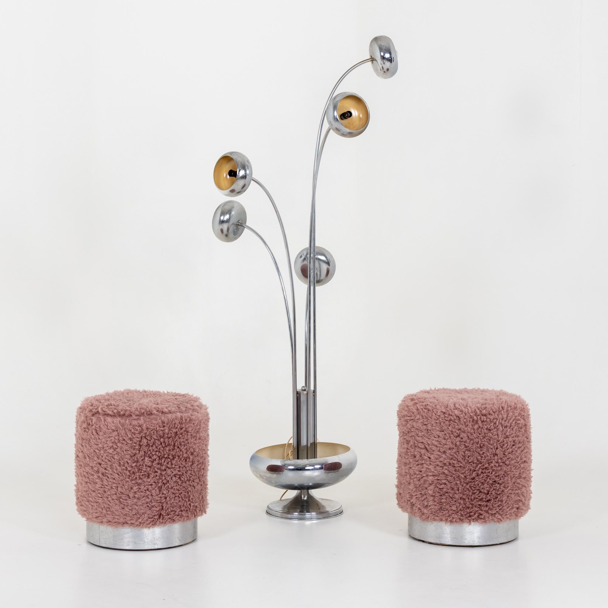 Pair of cylindrical stools with pink faux fur cover.