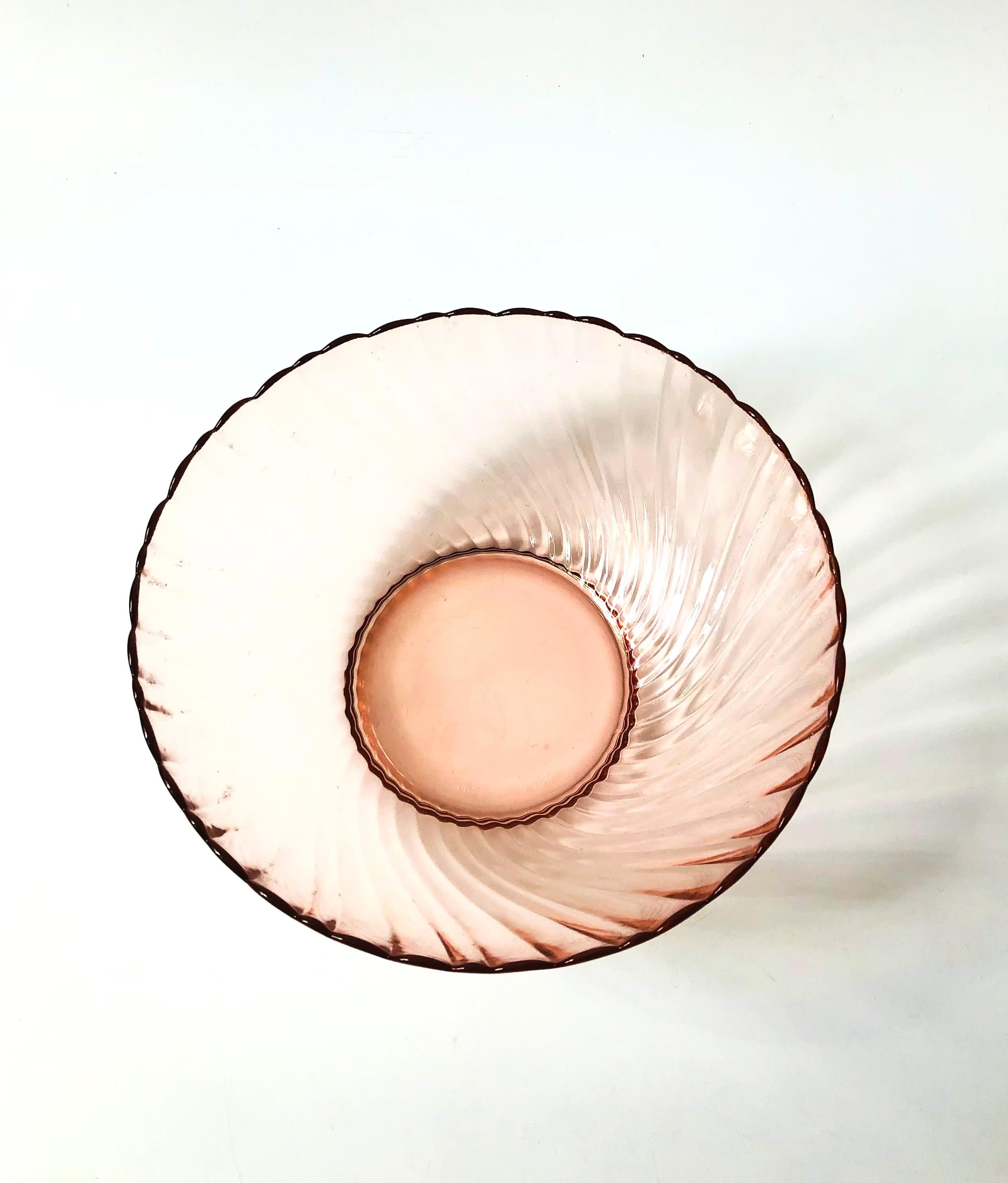 A large vintage glass salad bowl in a blush pink color. Beautiful swirl texture to the glass. Made in France by Arcoroc in the rosaline swirl pattern.

