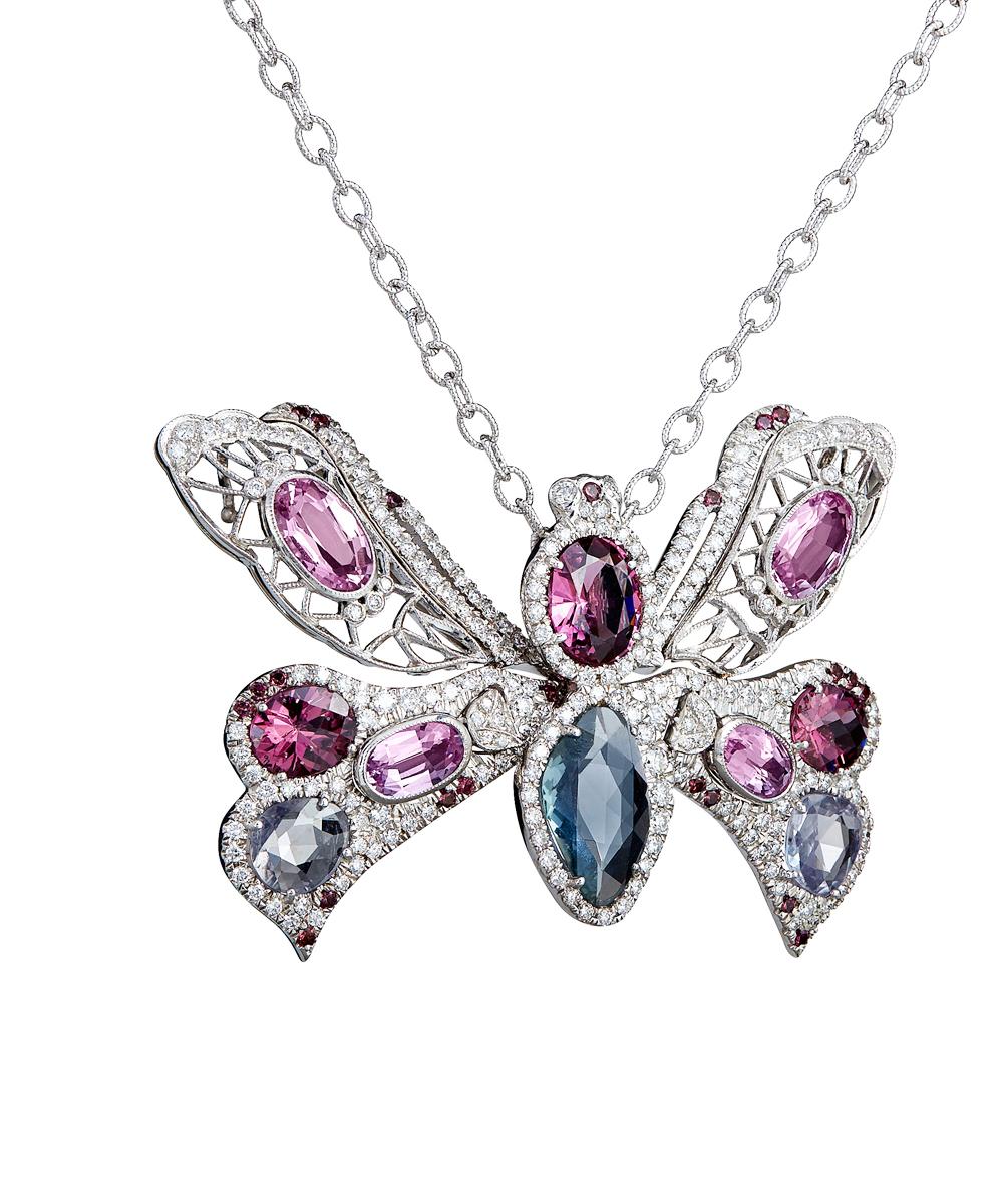 Pink topaz, diamond and sapphire butterfly.  This one of a kind pink butterfly pendant is set with 4 oval precious pink topaz ( no heat) with a weight of approx. 12 cts along with three blue purple rose cut sapphires approx. 6.02 CTS total weight,