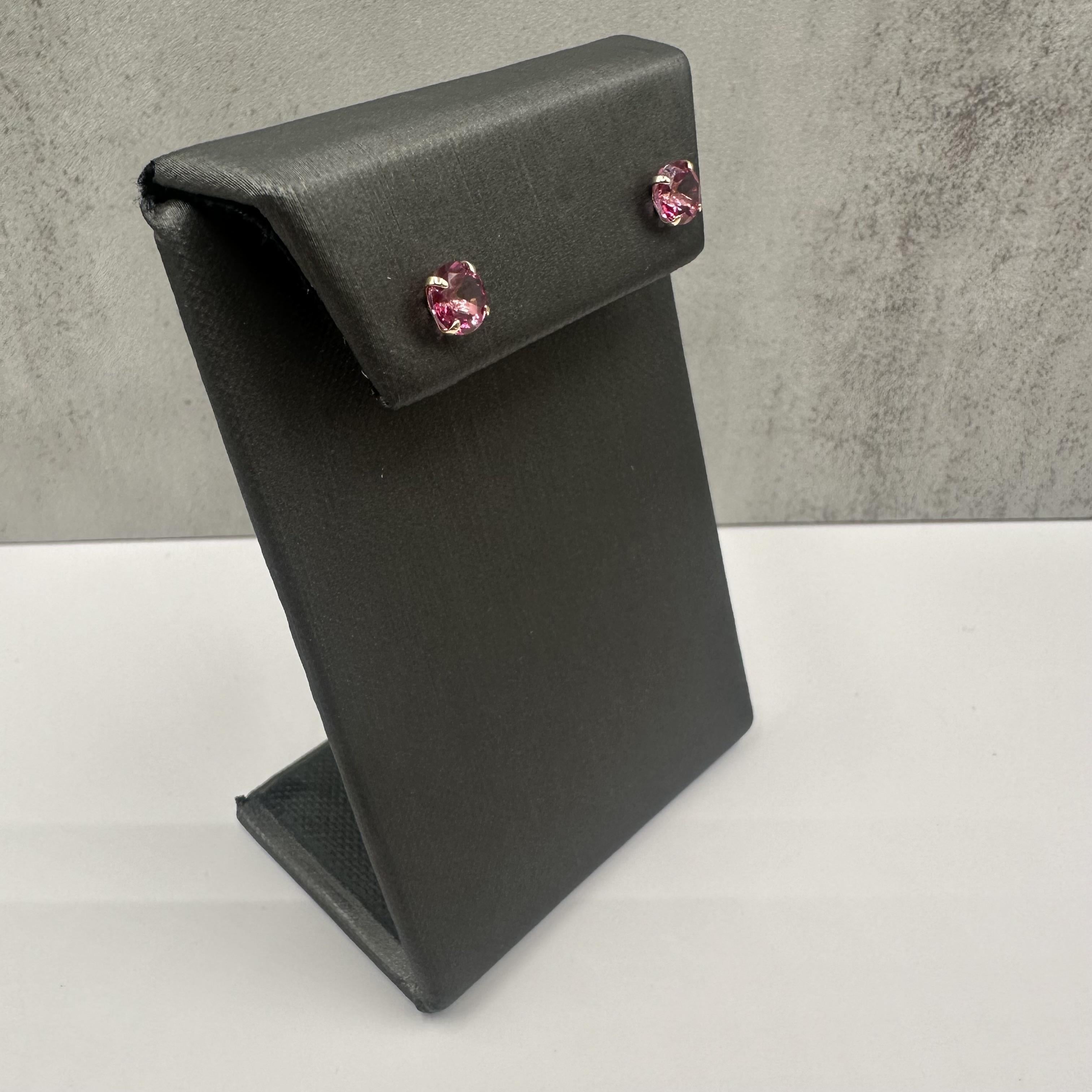 Add a splash of vibrant color to your jewelry collection with these stunning Pink Topaz Studs, crafted in 10kt Yellow Gold. Featuring 2 carats total weight (ctw) of round pink topaz stones, these earrings offer a bright and eye-catching look,