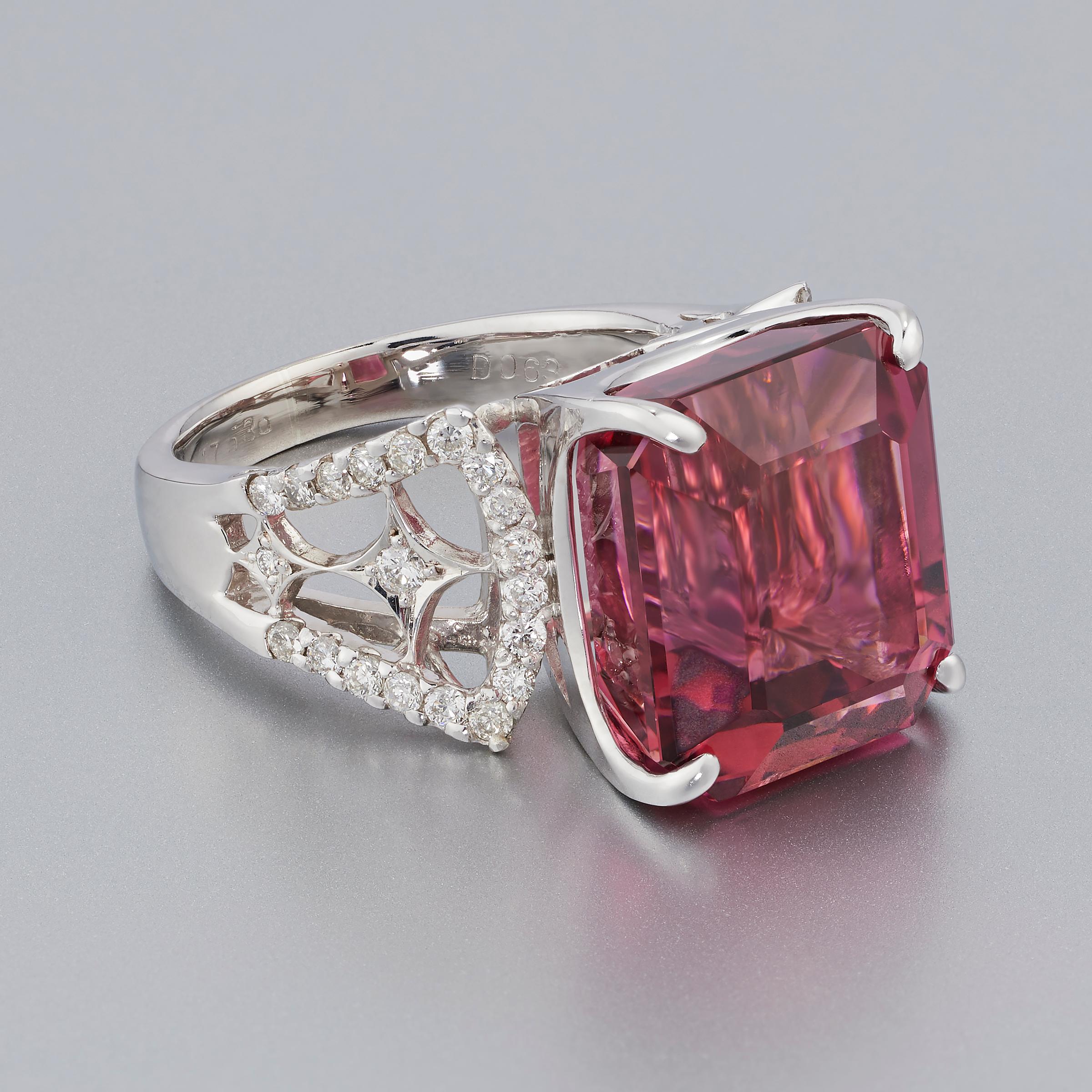 Superb natural pink tourmaline of impressive 14 carats is the highlight of this beautiful ring handcrafted in 18 karat white gold and accented by fine white diamonds. The stunning tourmaline displays a richly saturated and vibrant color with fiery