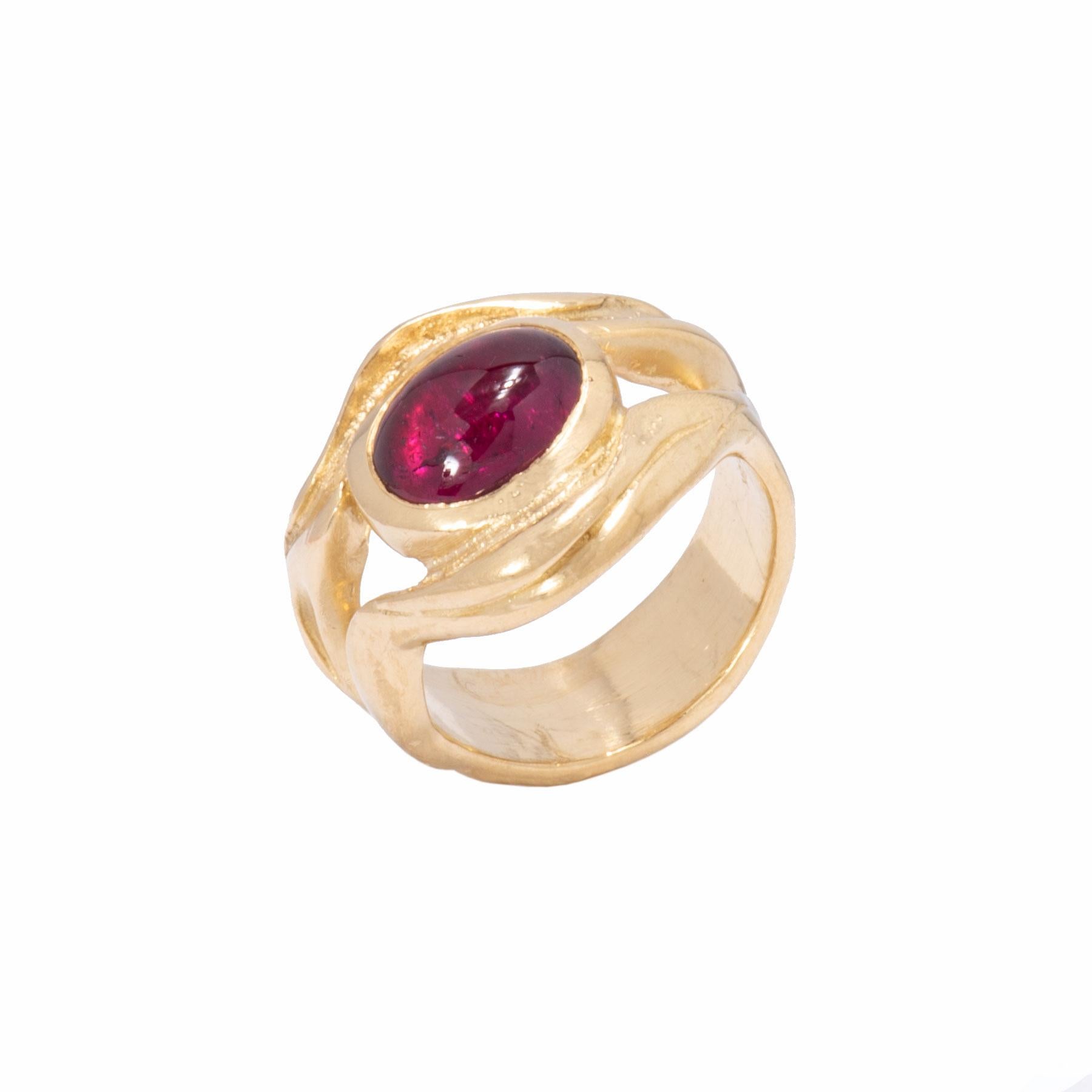 A very cherry pink tourmaline 2.64cts is embraced in waves of 18 karat gold which flow into the shank of our Split Ripple Ring. The face and shanks of the Split Ripple Ring are carved like a flow of 2 streams parting around a magnificent pink