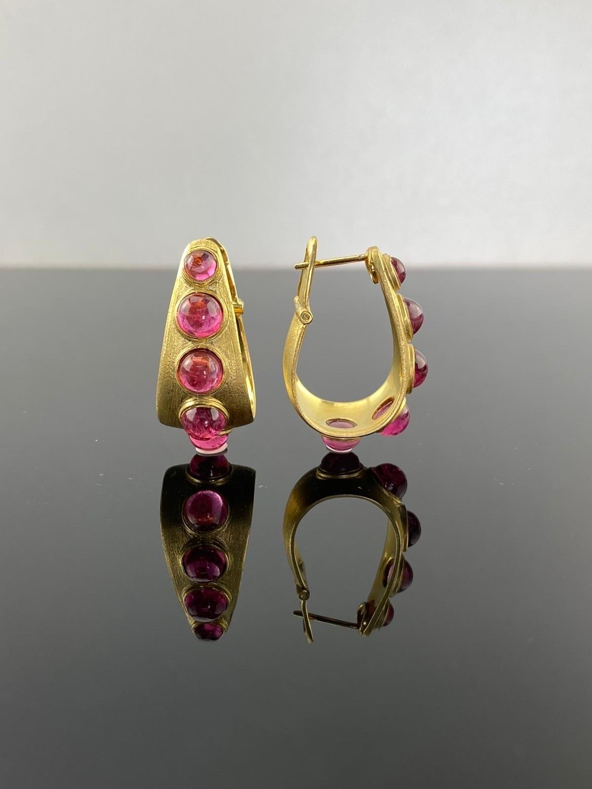 A pair of 18k Gold hoop earrings set with round cabochon Tourmaline. This beautiful statement earrings are great present for yourself or loved ones. Set in solid 18K Gold, with a matte finish polish which make the earrings extra special and