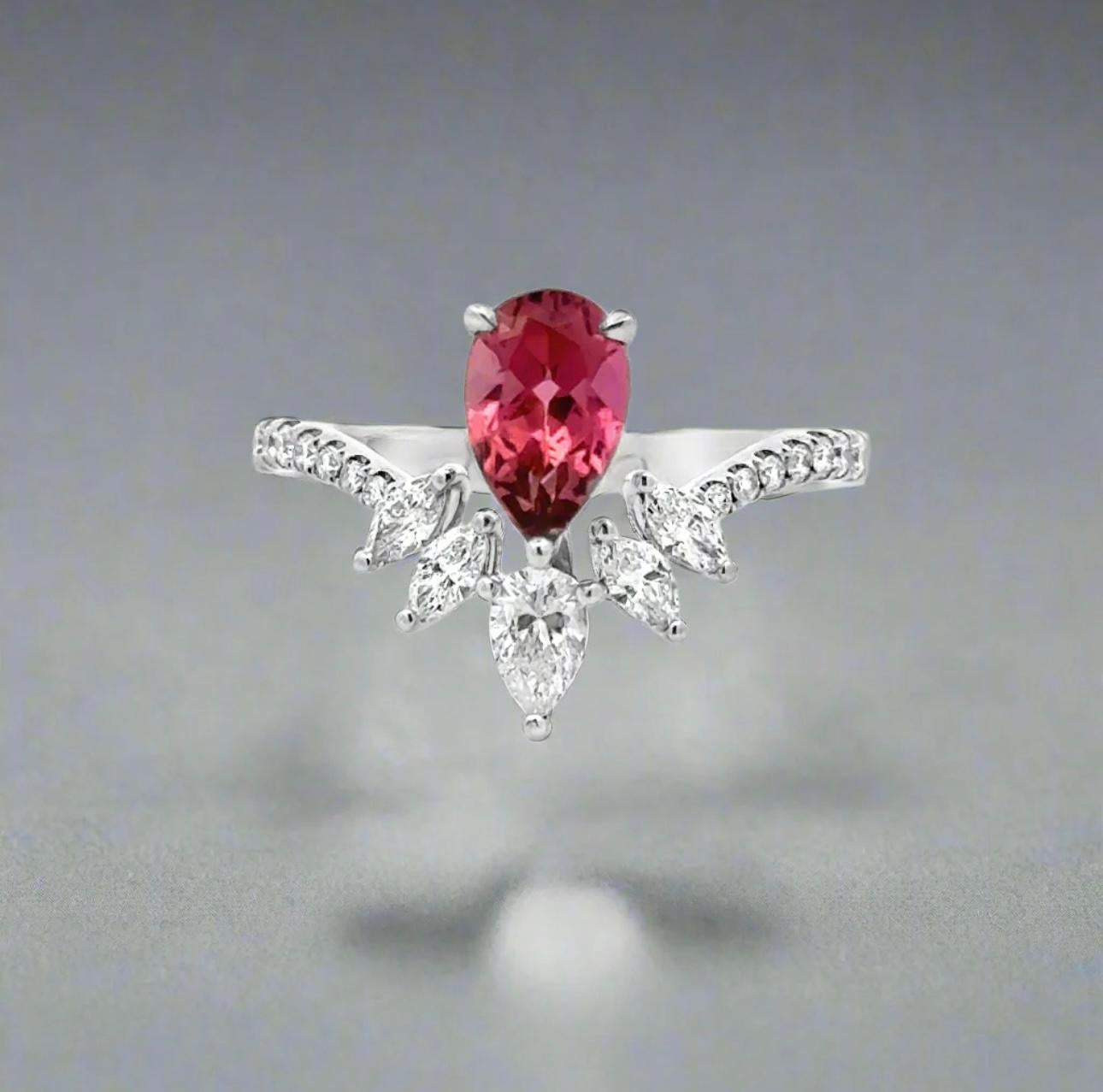 This elegant cocktail ring is expertly crafted with 18K white gold and features a stunning design with a vibrant pink tourmaline gemstone and sparkling diamonds. The perfect accessory for any special occasion, this ring adds a touch of