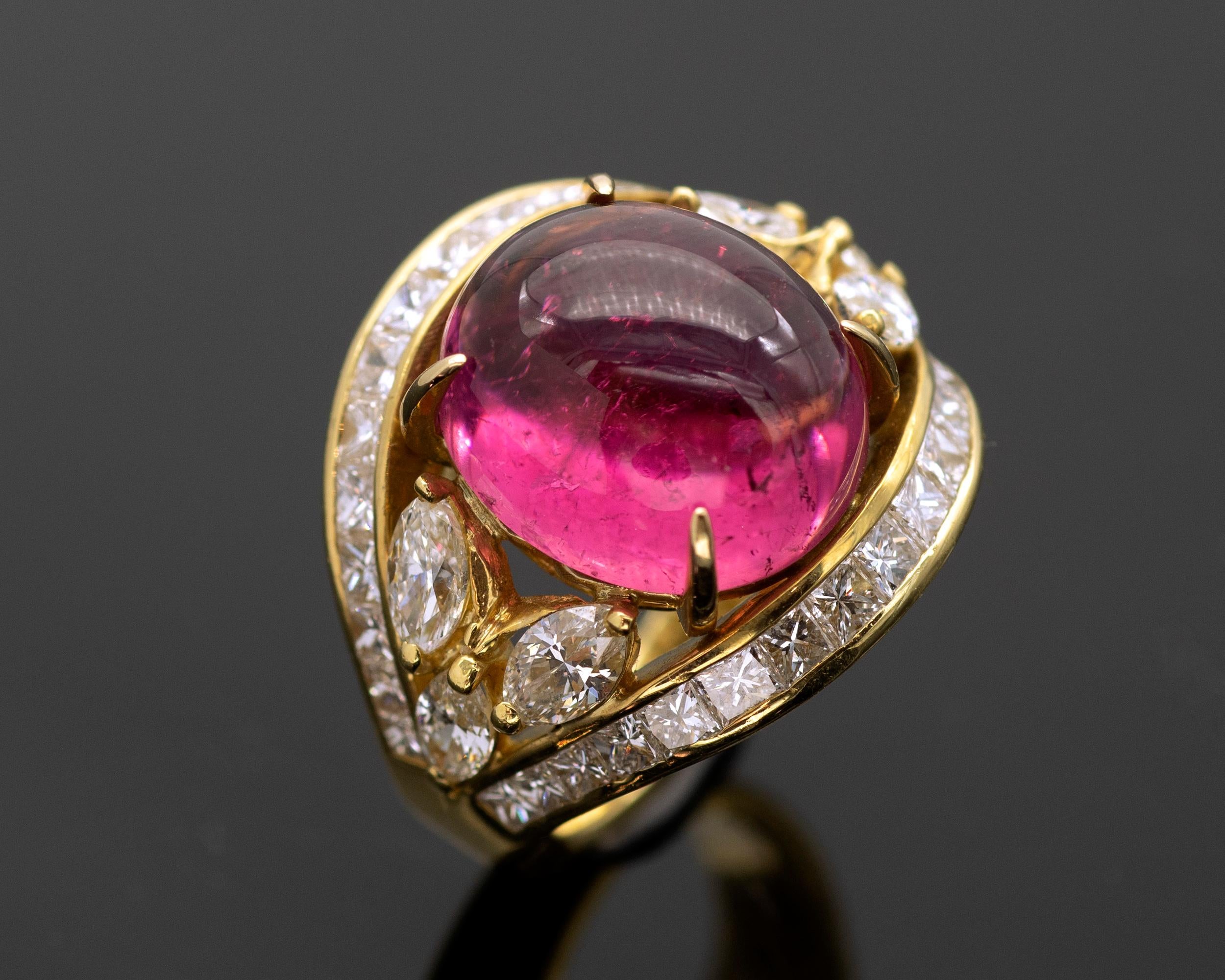 Elegant Cocktail ring,  An important pink tourmaline cabochon is set wit four shiny claw like prongs. on each sides of it three navette cut diamonds. These central gemstones are embedded between two lines of princess cut  diamond.
The ring is in