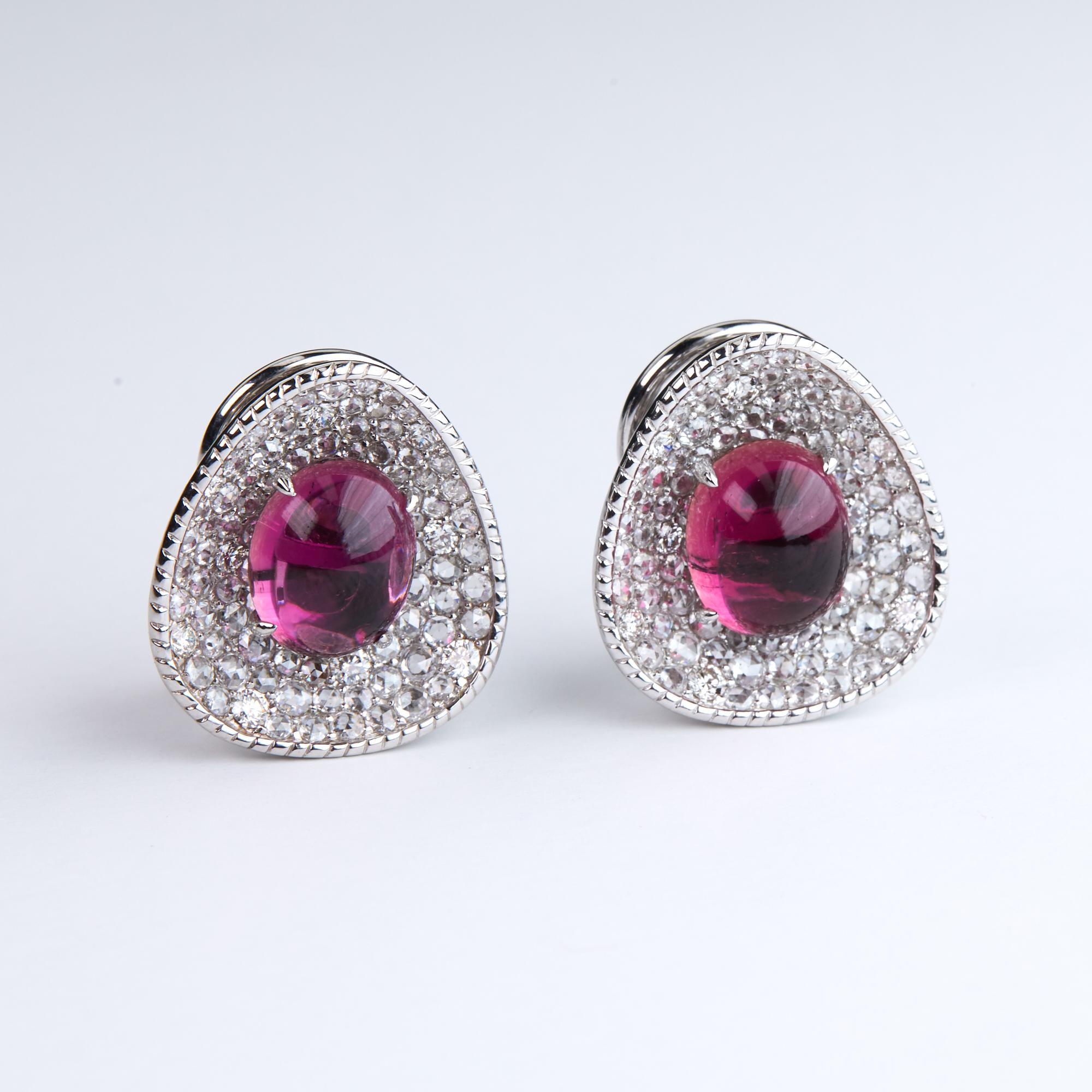 Pink Tourmaline and Diamond Earrings.  These one of a kind earrings boast 8.07 carats of Cabochon Pink Tourmaline centers sitting on a bed of rose cut diamonds (2.51 carats) and brilliant round cut diamonds (.55 carats) total weight of 3.06 carats.