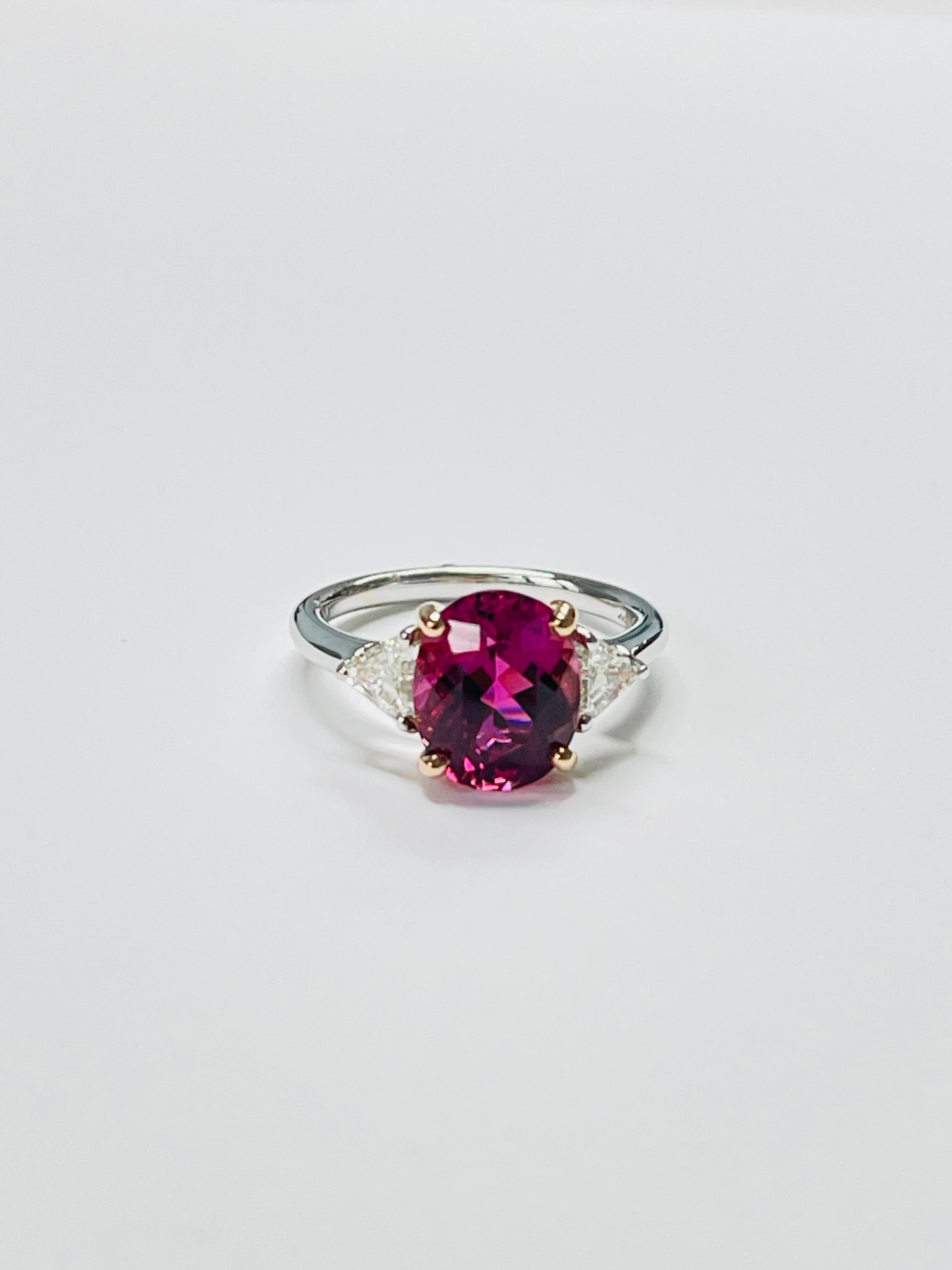 Gorgeous pink tourmaline and diamond three stone engagement ring beautifully hand made in 14k white gold. 

The details are as follows; 
Pink tourmaline weight : 3.53 carats 
Diamond weight : 0.72 carat
Metal : 14k white gold 
Ring size : 6 1/4 