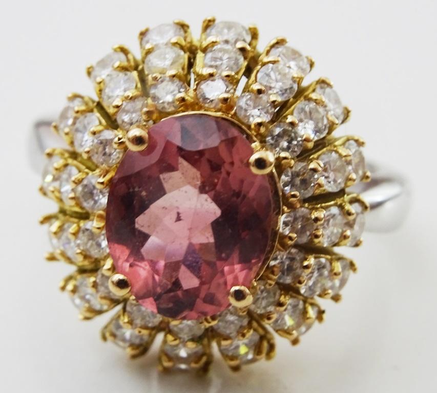 A retro Ring from the 1960's.
Made in fully hallmarked 14 karat Gold.
The Centre Stone is 9 x 11 mm oval Pink Tourmaline.
It is surrounded by 3 rows of Diamonds.
8 stones of 10 points each.
12 stones of 5 points each.
16 stones of 2.5 points