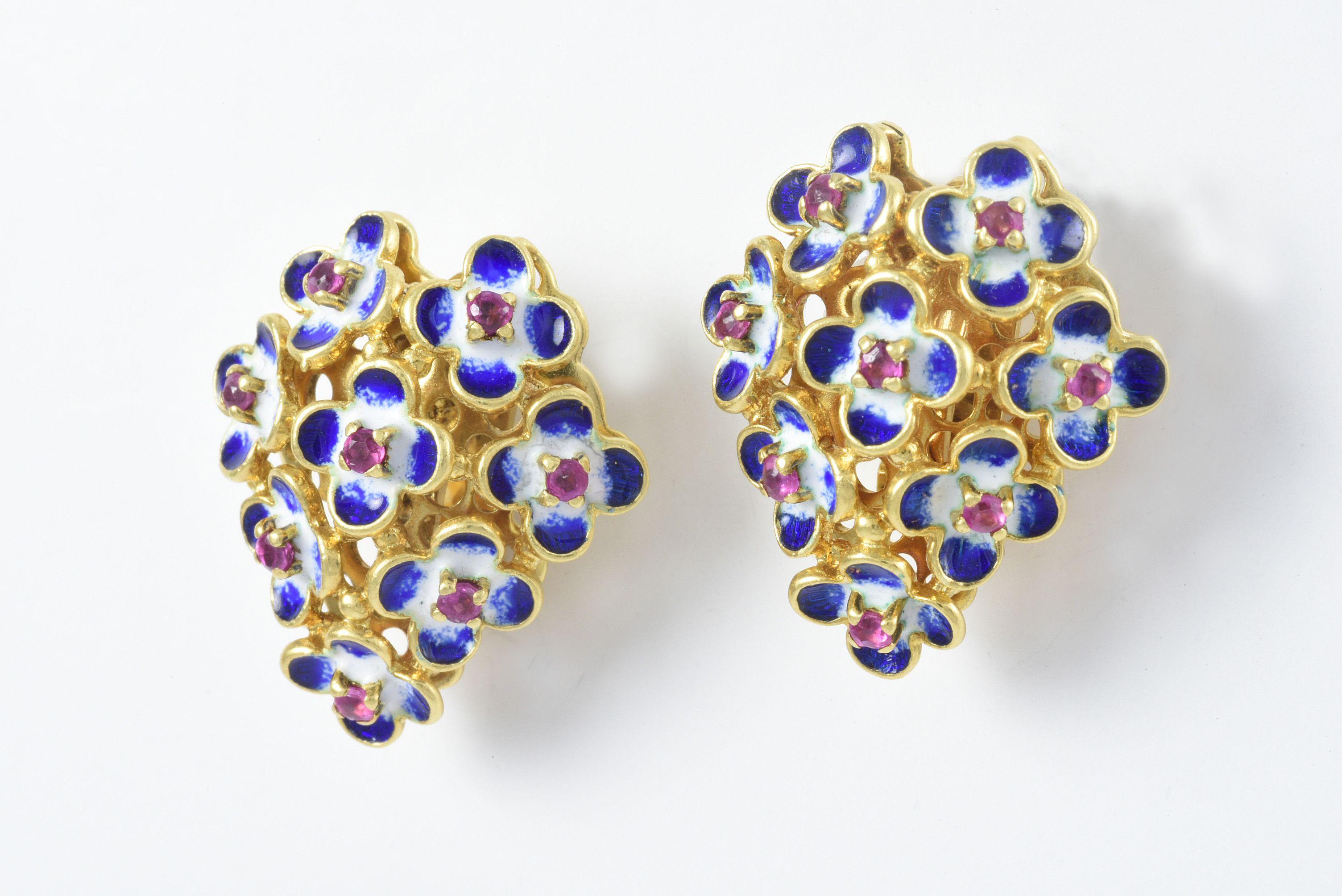 Fashioned in 18kt yellow gold, these vintage Italian-made earrings feature sixteen round pink tourmalines that center delicate white and blue enamel petals to create a beautiful floral motif and secured with omega backs. 