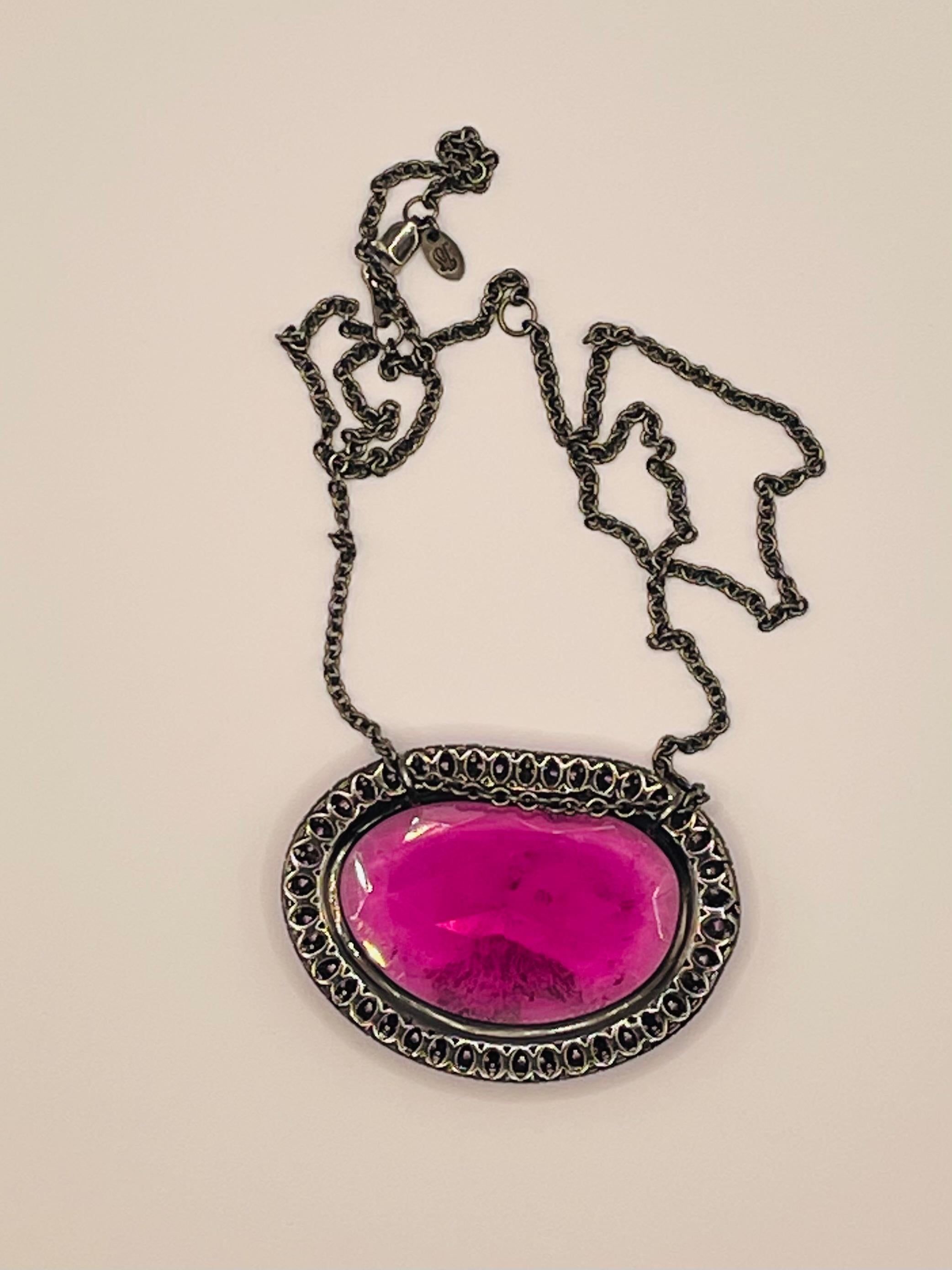 Pink tourmaline slice and pink sapphires pave  necklace set in 18k white gold and covered in black rhodium. Chain is 17 in but also can be worn as 16 in.One of a kind ,eye catching piece of jewelry.
