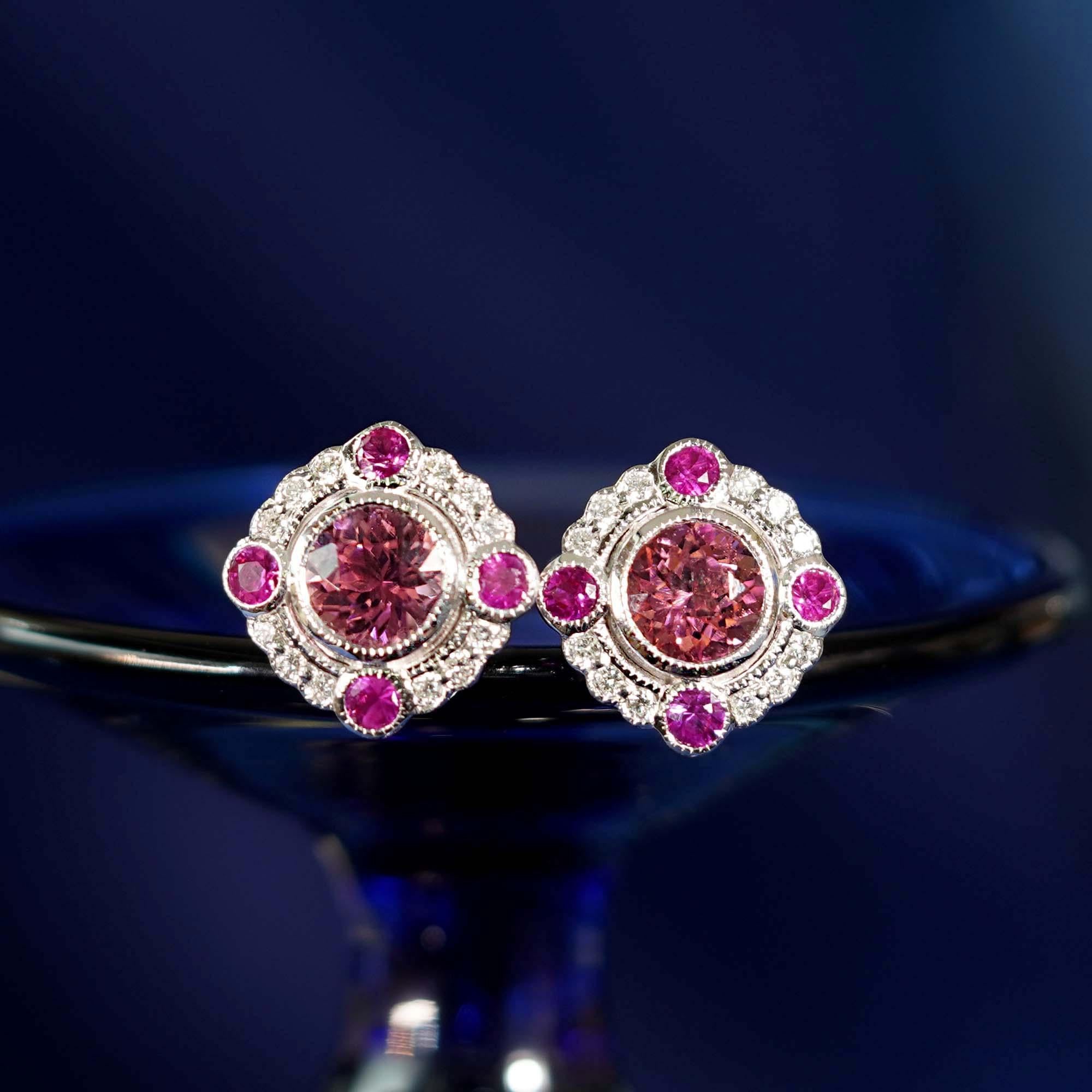 With pretty vintage styling, these earrings make the perfect finishing touch to an outfit. Featuring pink tourmaline in the center and four round rubies with tiny diamond halo that give a subtle, glittering appearance. The edges of the design have