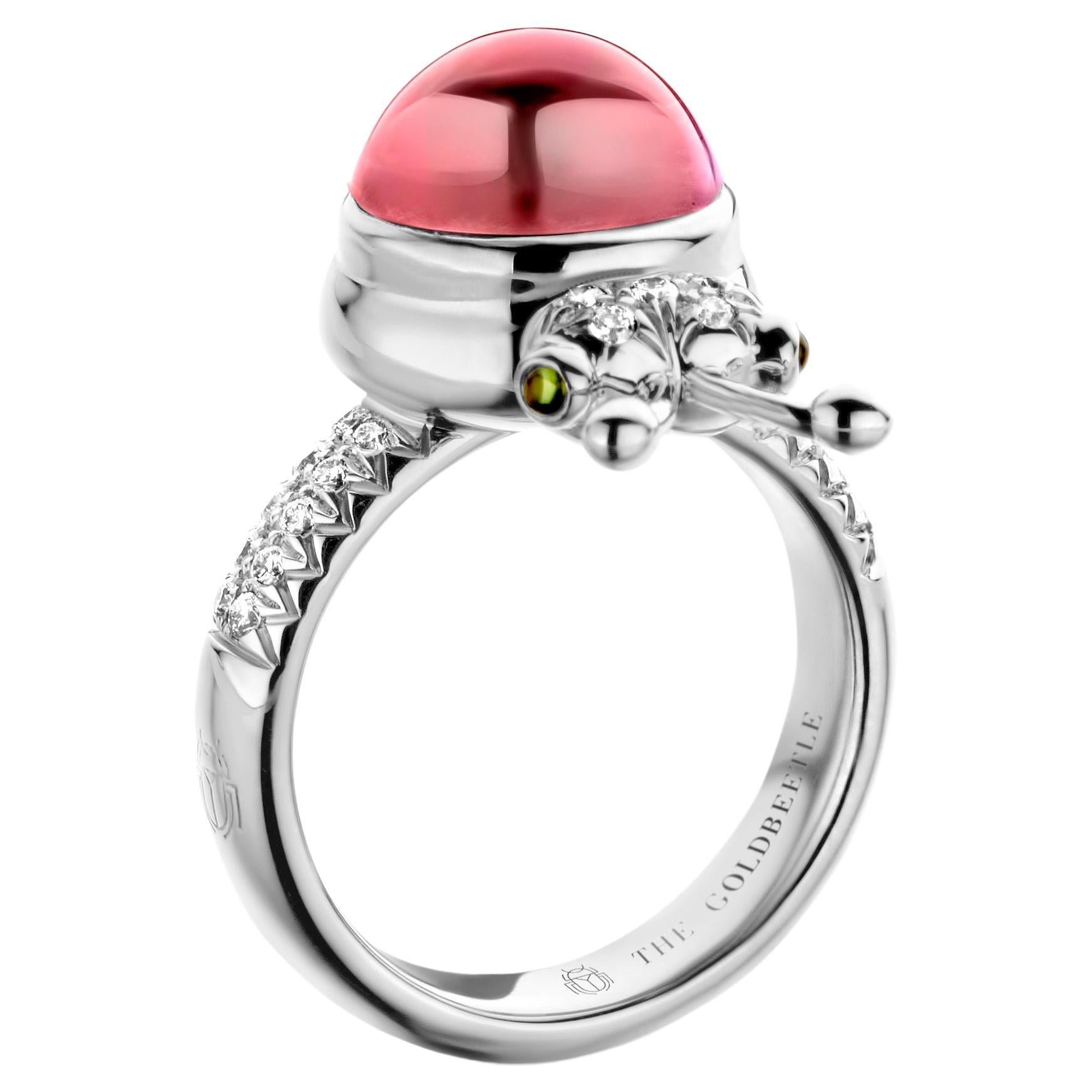 One-of-a-kind lucky beetle ring in 18-Karat white gold 10g set with the finest natural diamonds in brilliant cut 0,23 Carat (VVS/DEF quality) one natural, pink tourmaline in round cabochon cut 6,00 Carat and two tsavorites in round cabochon cut.