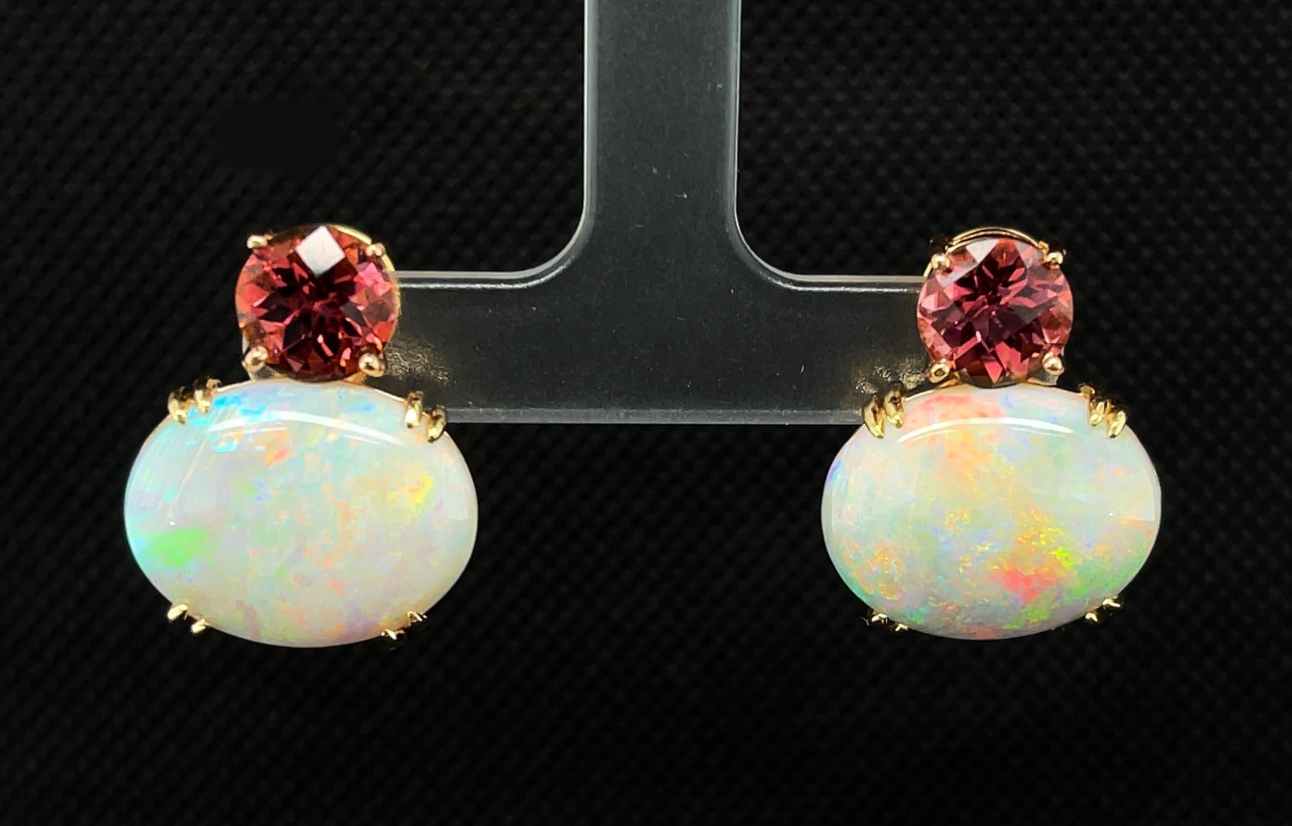 A kaleidoscope of vibrant colors can be seen in these gorgeous earrings featuring gorgeous  Australian opals. It is very rare to find a beautifully matched pair of fine quality opals in such a large size. They are accented by peach colored