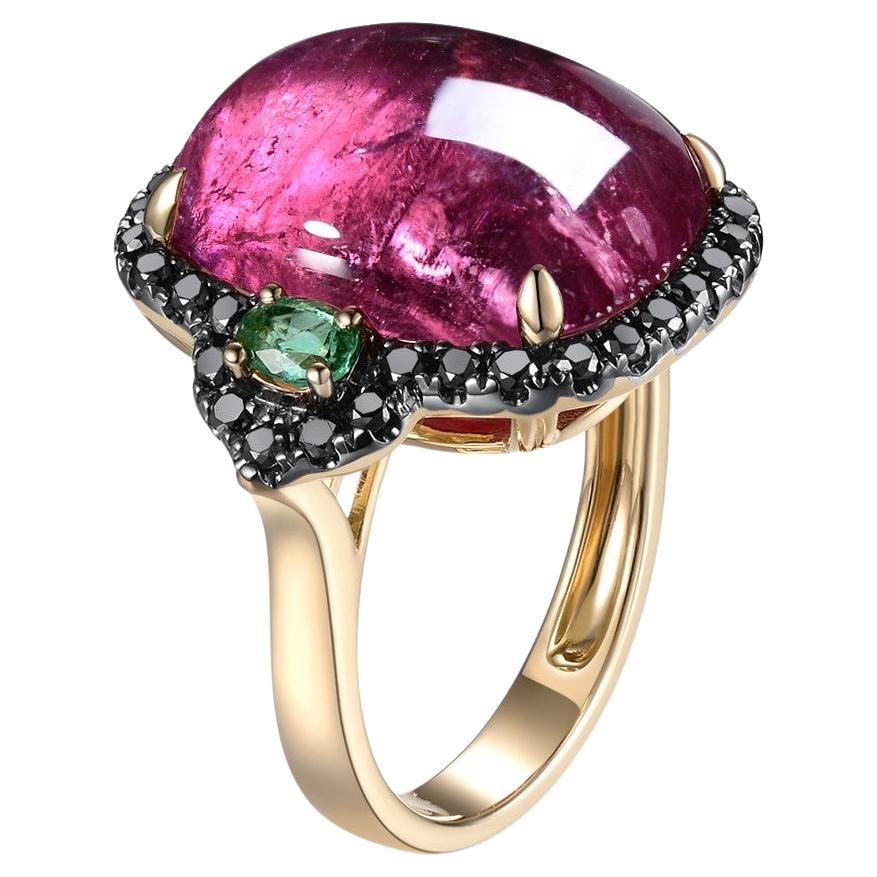 This pretty ring features a cushion tourmaline weight 12.44 carats, the tourmaline shows pink and purple hue . This ring is set in a dazzling black diamonds halo flanked with 2 emeralds 14k yellow gold design that showcases its captivating beauty.