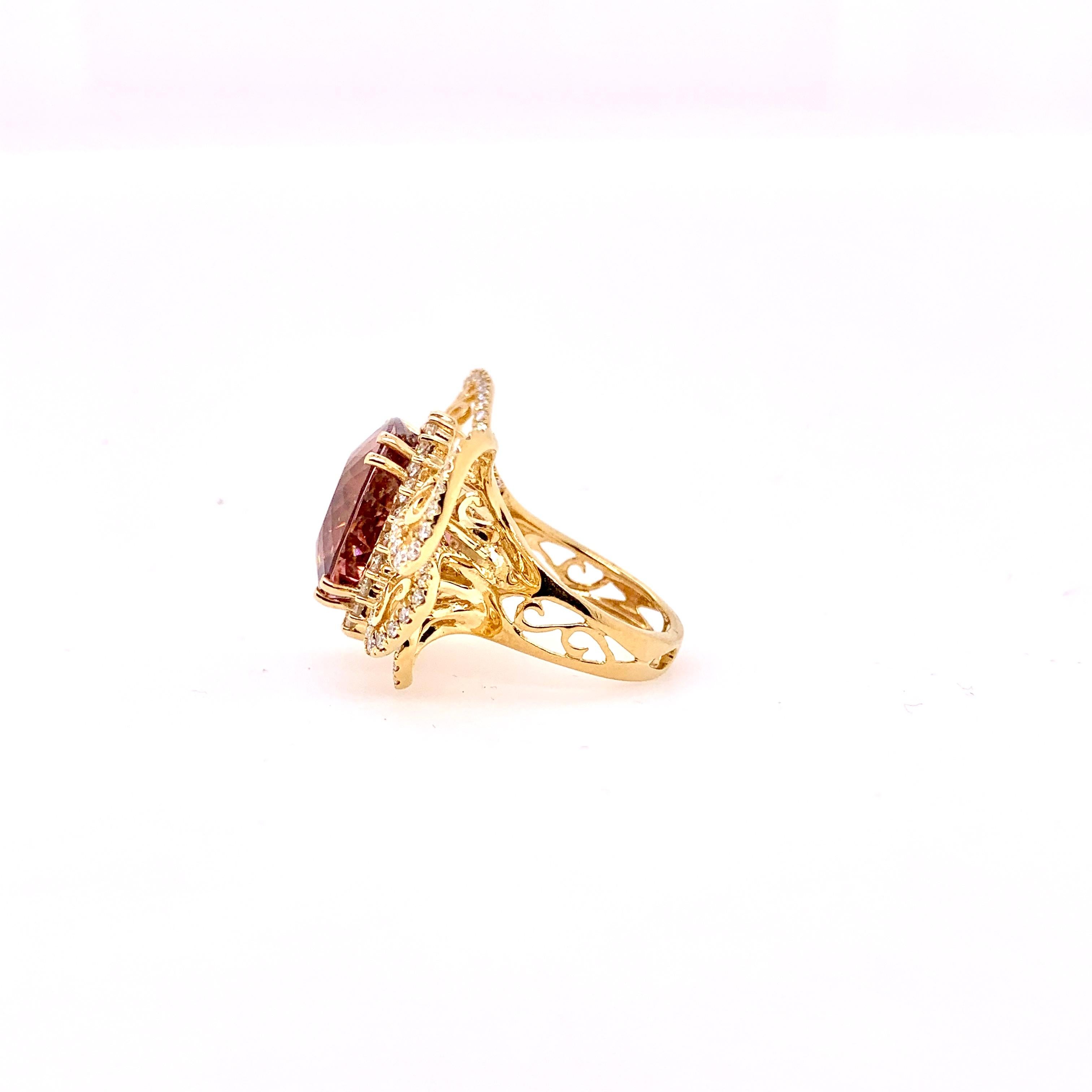 A unique approach to a pink tourmaline butterfly ring with diamonds.  Handmade with an artistic viewpoint on a more contemporary butterfly design.   The cushion cut pink tourmaline weights 14.5 cts and the round brilliant diamonds come in at 1.70