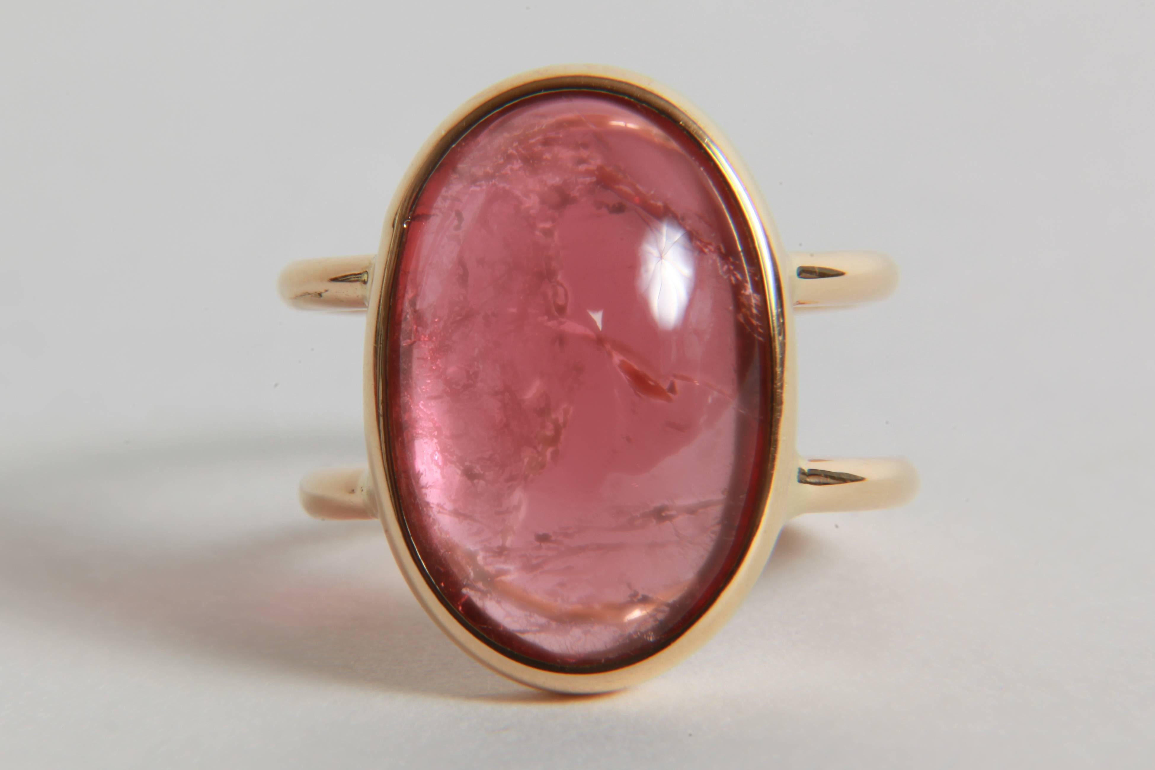 A pastel pink colour for this beautiful and voluminous ovale cabochon on a double 18K yellow gold ring. Simple and elegant. 
Tourmaline cabochon : 17.12 carats
 finger size : 52.5 or 6 1/4. 
Can be sized.
French assay mark, created by Marion