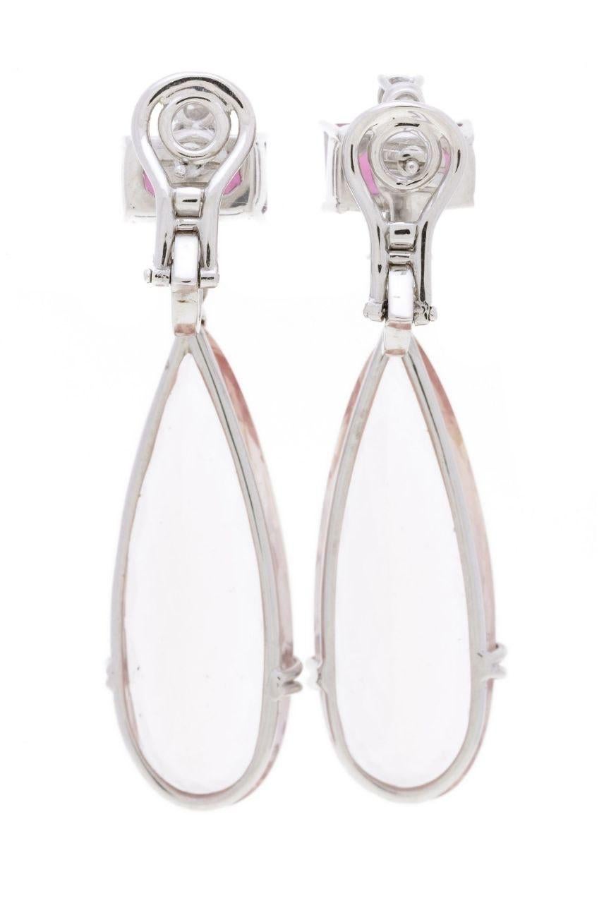 Trendy and versatile, these earrings are  handcrafted in 18 K Solid White Gold and set with pink Tourmalines and round cut White Diamonds. They feature deep purple and pale pink tourmalines.

These dangle earrings can elevate your look with the