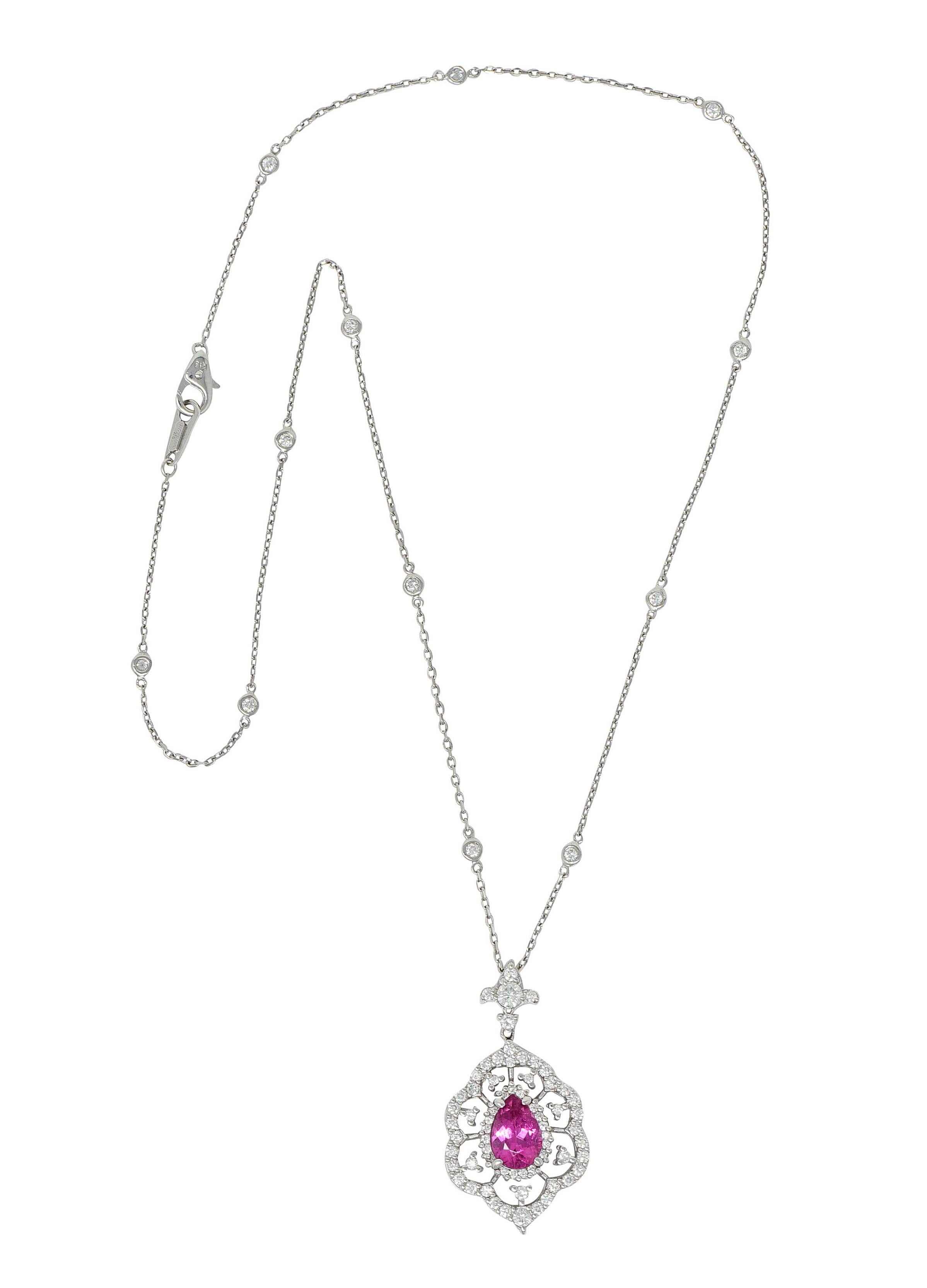 Diamonds-by-the-yard style cable chain necklace features ten bezel set round brilliant cut diamond stations

Suspending a grandiose cluster pendant centering a pear cut tourmaline measuring approximately 10.0 x 6.2; hot pink in color

With a