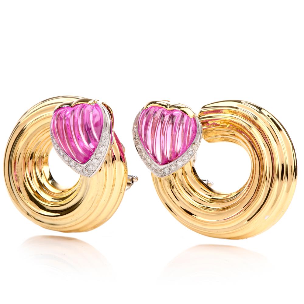 These feminine pink tourmaline and diamond earrings are crafted with 18-karat yellow gold, weighing 43.7 grams and measuring 31mm long x 28mm deep. Bezel-set with a pair of heart-shaped pink tourmalines, with a rigid linear design, weighing