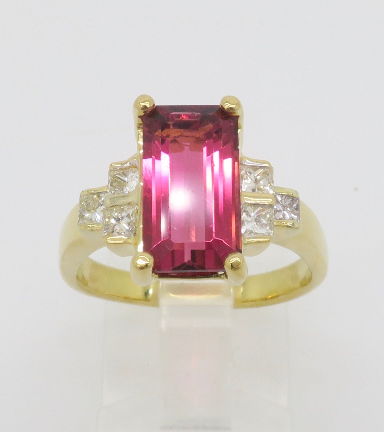 Pink Tourmaline & Diamond ring crafted in 18k yellow gold. 

Gemstone: Pink Tourmaline & Diamond
Diamond Carat Weight: .60CTW
Diamond Cut: Princess Cut Diamonds
Diamond Color: F-G
Diamond Clarity: VS
Tourmaline Carat Weight: Approximately