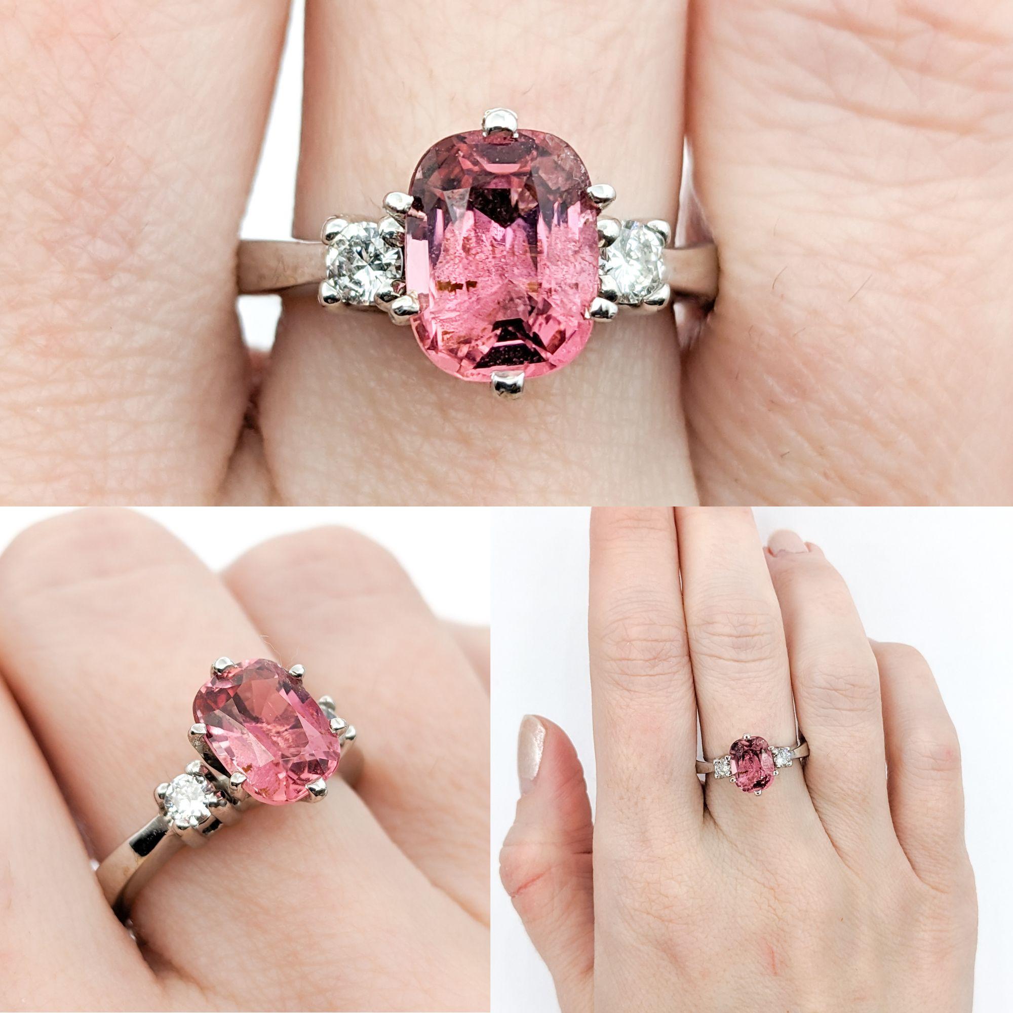 Pink Tourmaline & Diamond Dress Ring

This beautiful ring is crafted in 14kt white gold and features a 1.82ct cushion-cut pink tourmaline and .23ctw round brilliant-cut diamonds, SI2 clarity and G color. This ring is size 6 3/4 but can be adjusted