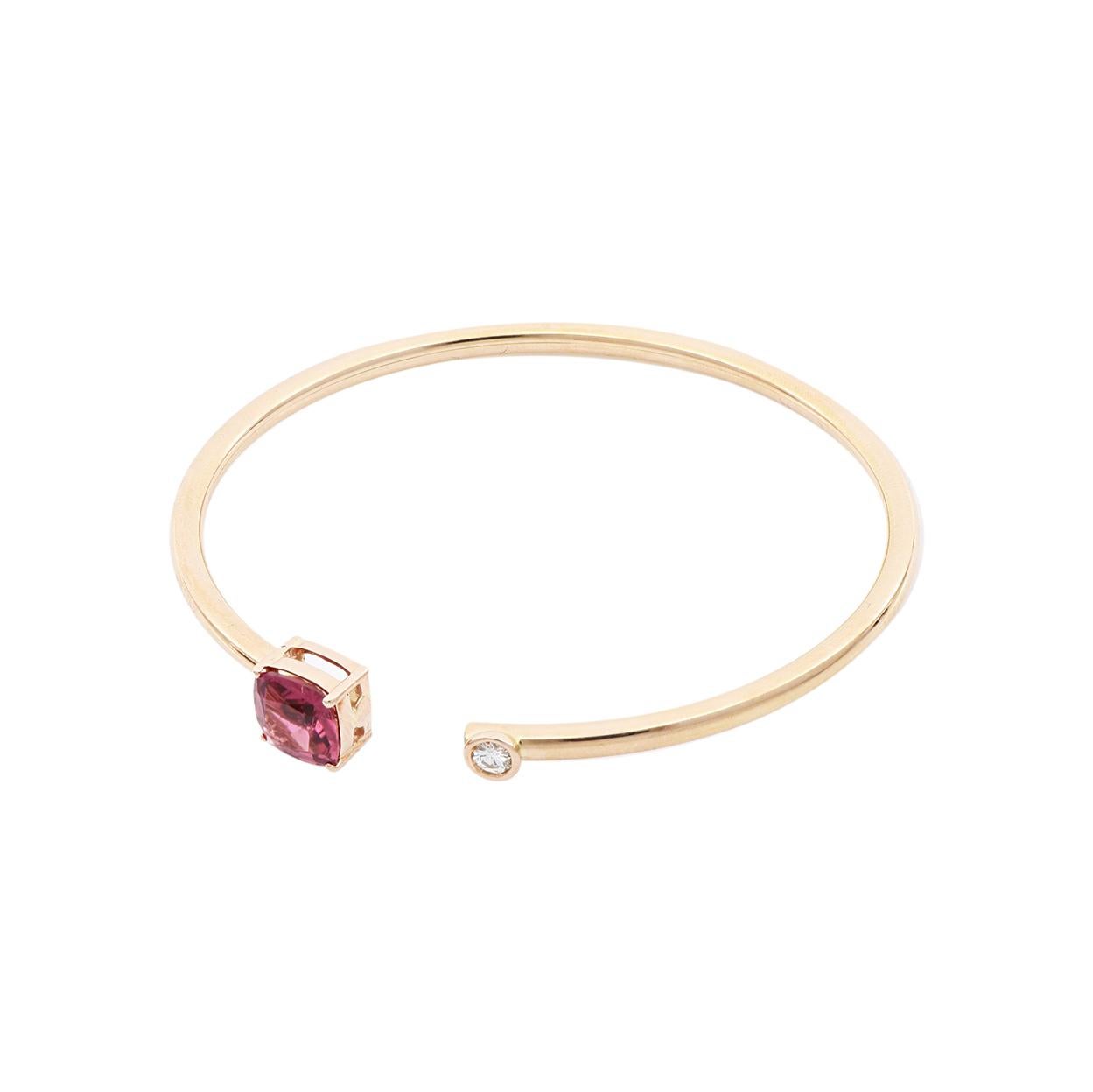 For a dainty, feminine look this bangle bracelet has all it takes: a sleek 18 Kt rose gold open-cuff with a square red tourmaline on one end and a round diamond on the other end. Tourmaline is the newer October birthstone that can help polarize