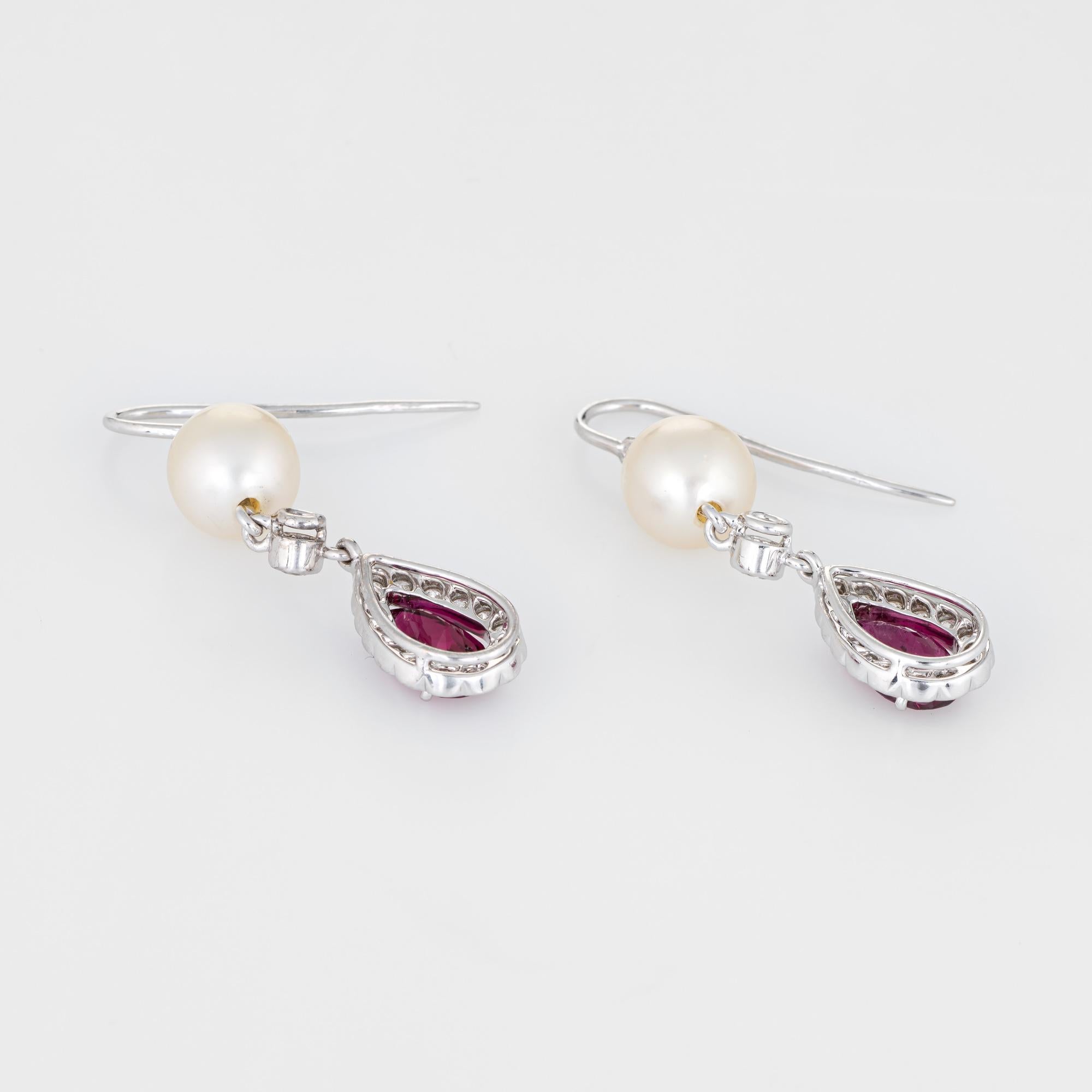 Elegant pair of estate pink tourmaline, diamond & cultured pearl earrings crafted in 18k white gold. 

Faceted pear cut pink tourmaline measures 8mm x 5mm (estimated at 0.85 carats each - 1.70 carats total estimated weight). The diamonds total an
