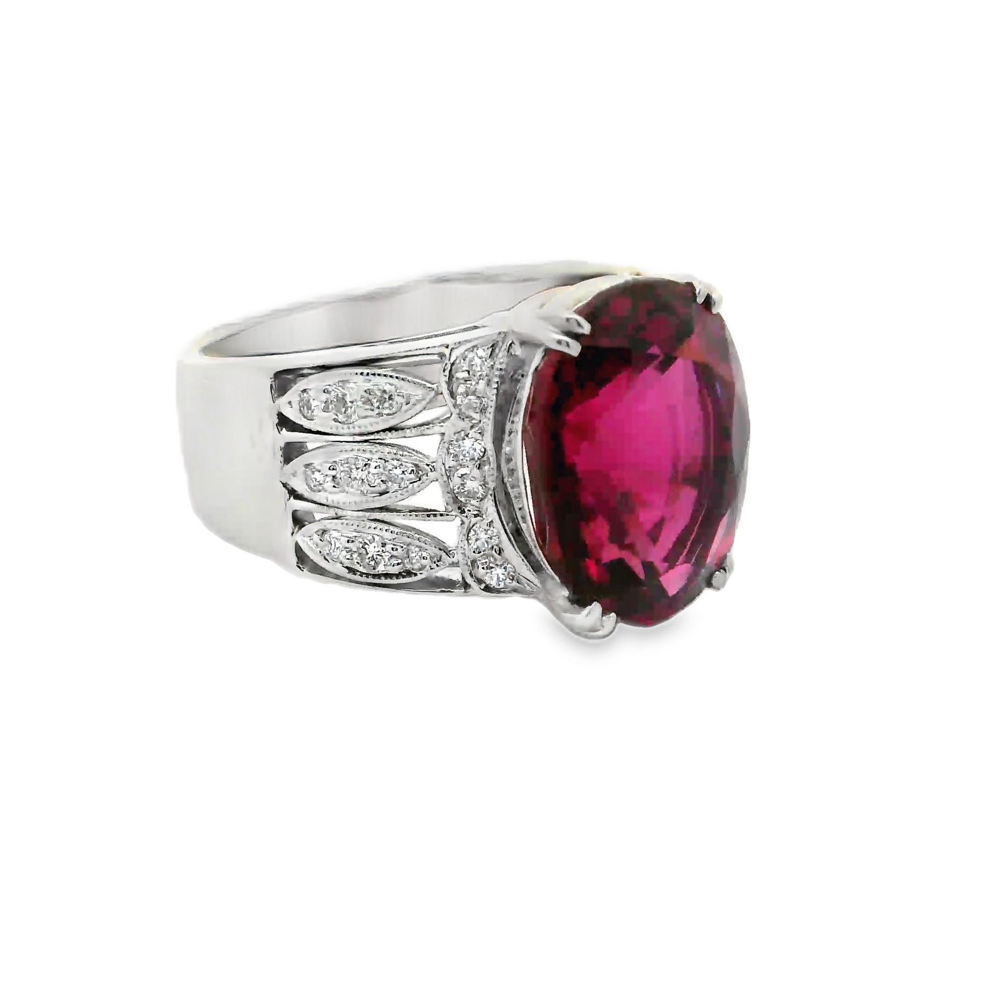 A striking oval-cut tourmaline commands attention. Weighing 6.04 carats, it boasts a vivid pink hue that captivates the eye. This centerpiece is flanked by 0.23 carats of round brilliant-cut diamonds, their white sparkle enhancing the tourmaline's